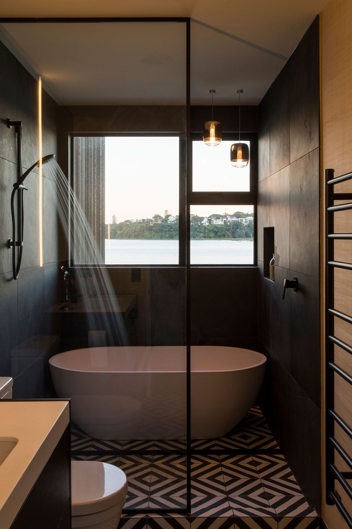 The guest bathroom on the upper-level enjoys a waterfront view.