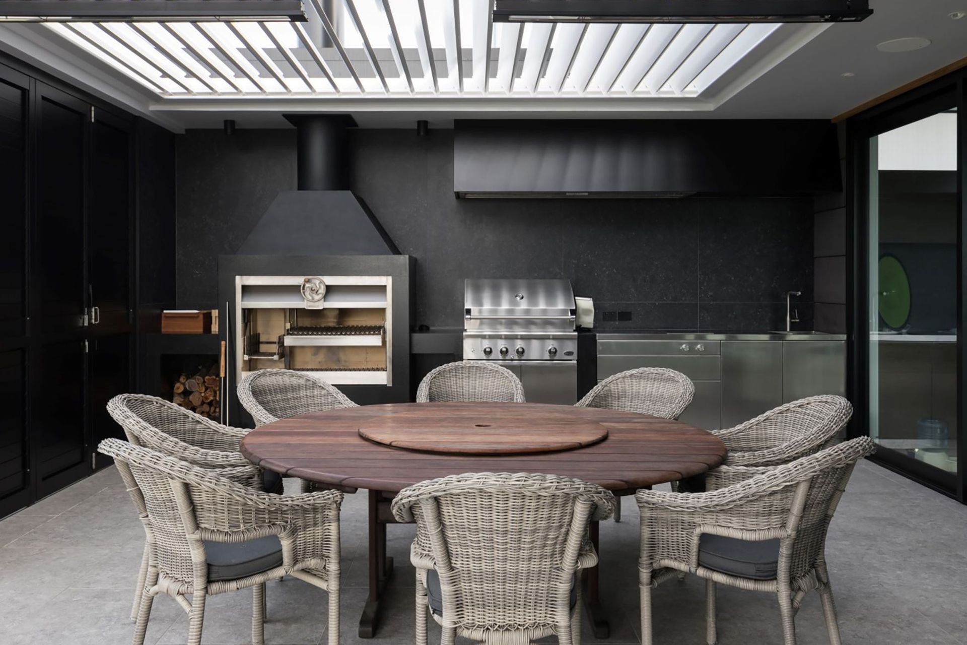 The outdoor room is directly linked to the kitchen and is the perfect place for entertaining, with adjustable overhead louvres providing light and shade.