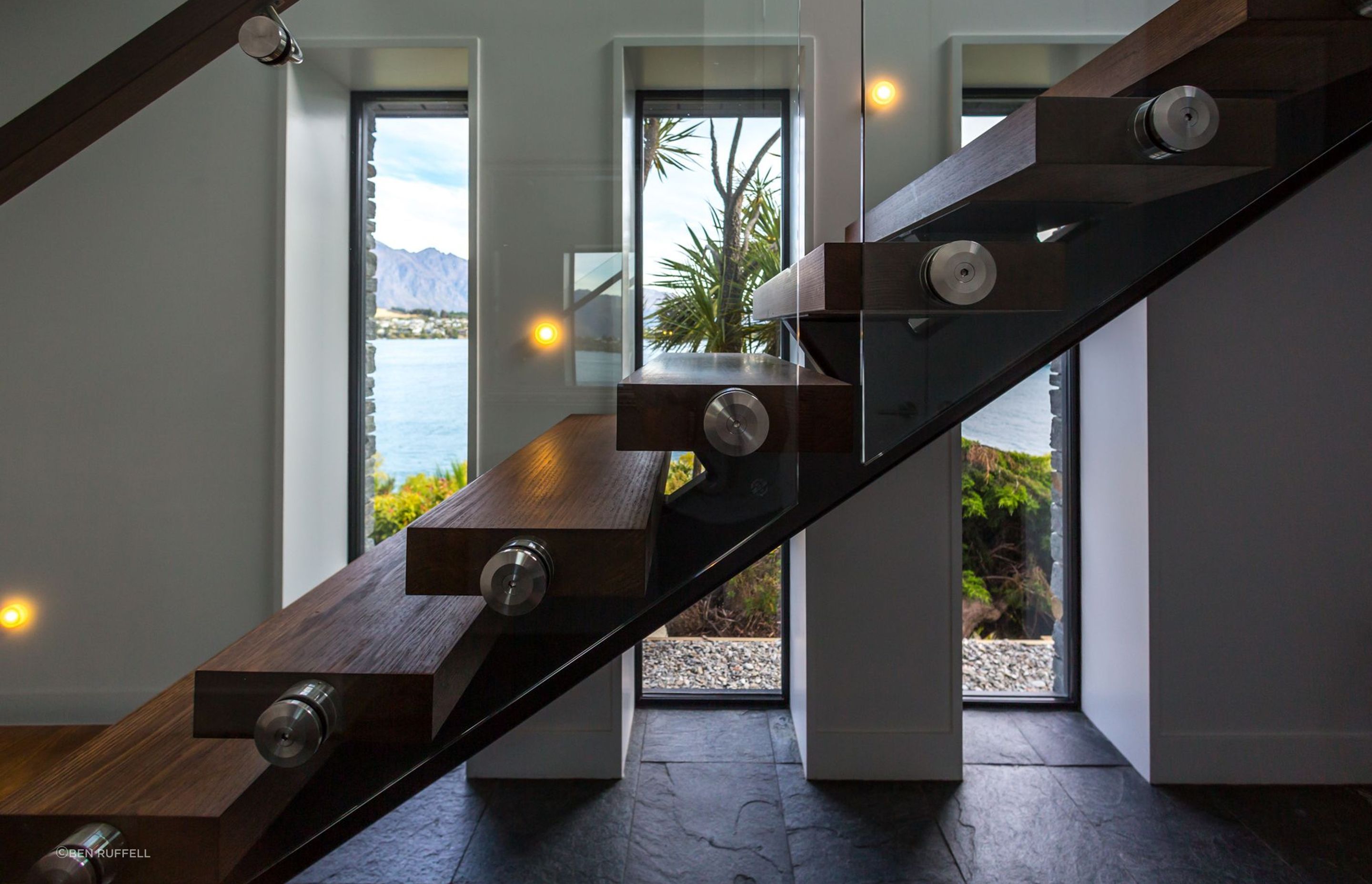 Deep recesses speak to the thermal capacity of the home while the floating timber staircase adds a dramatic flair to the entry.