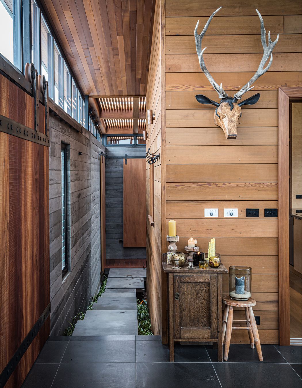 The entertainment room and walkway to the courtyard. Both photographs by ArchiPro.