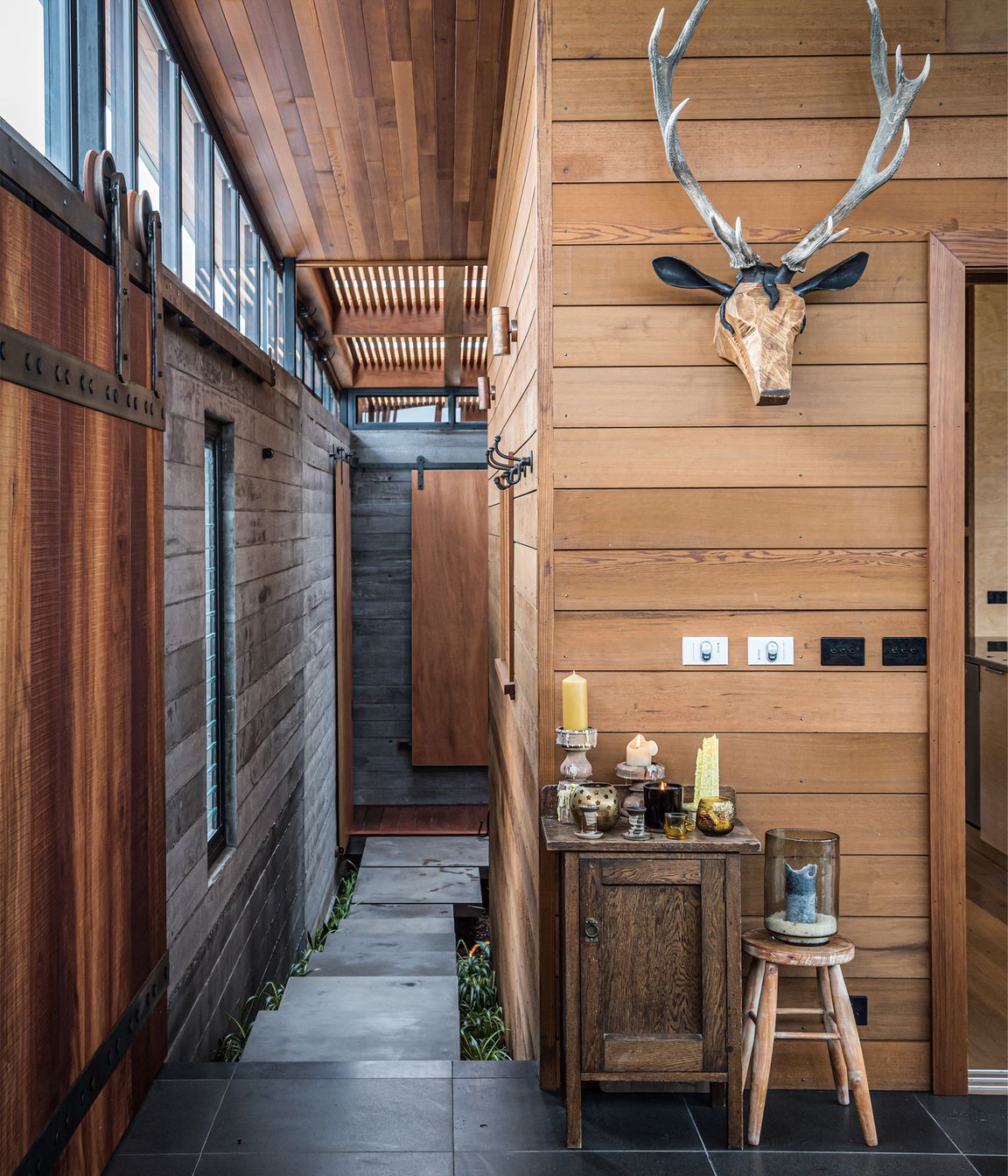 The entertainment room and walkway to the courtyard. Both photographs by ArchiPro.