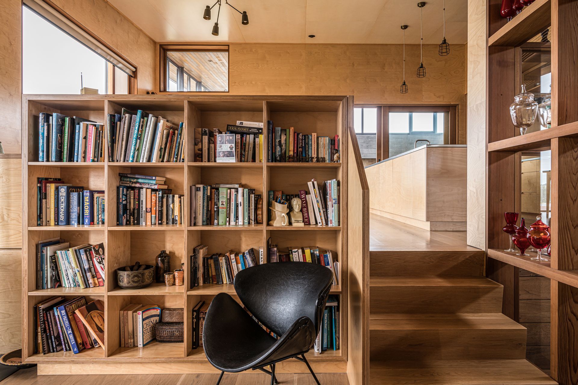 A casual lounge area is a cosy nook with a fireplace that keeps the space toasty during winter. Photograph by ArchiPro.