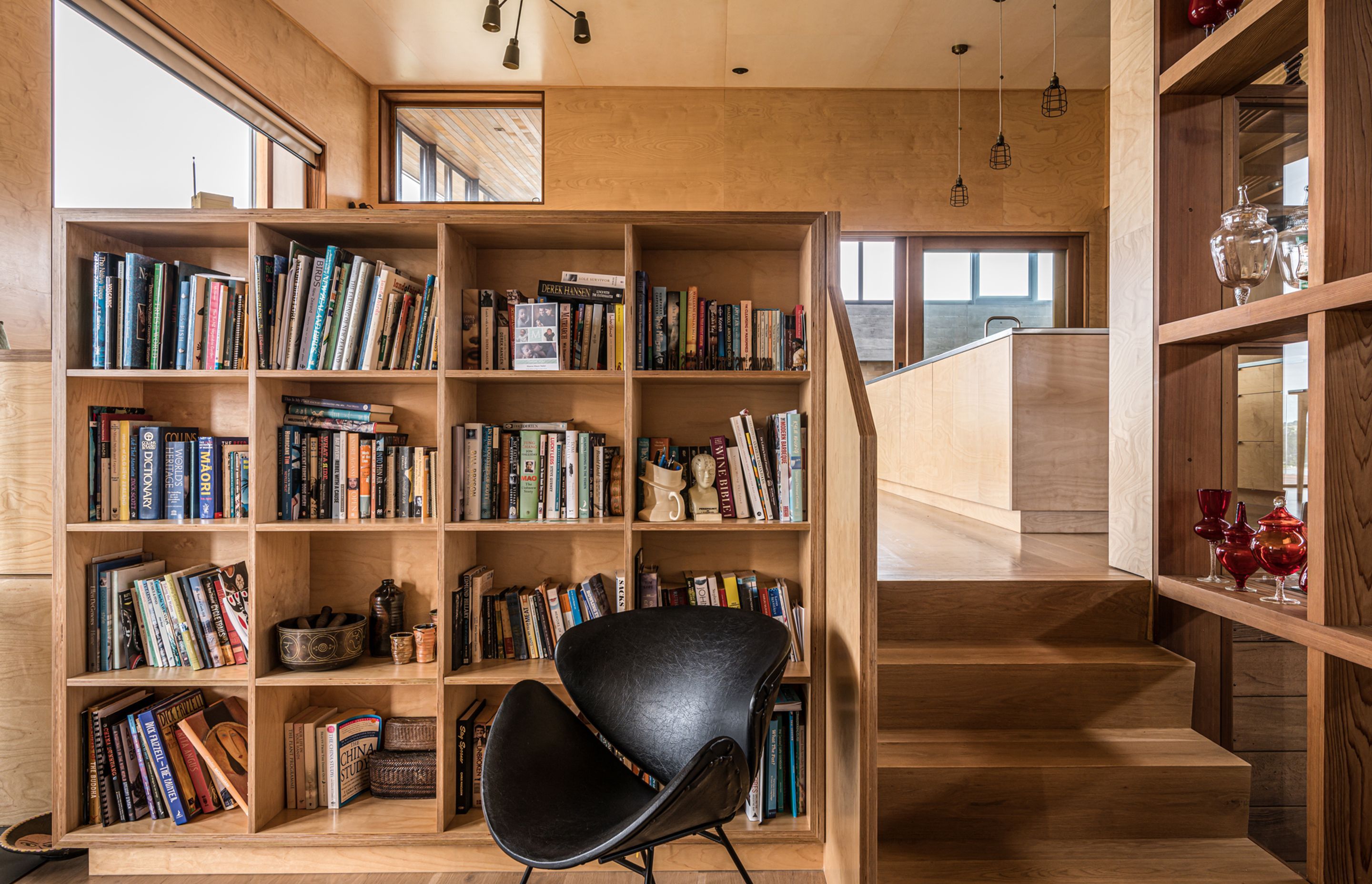 A casual lounge area is a cosy nook with a fireplace that keeps the space toasty during winter. Photograph by ArchiPro.