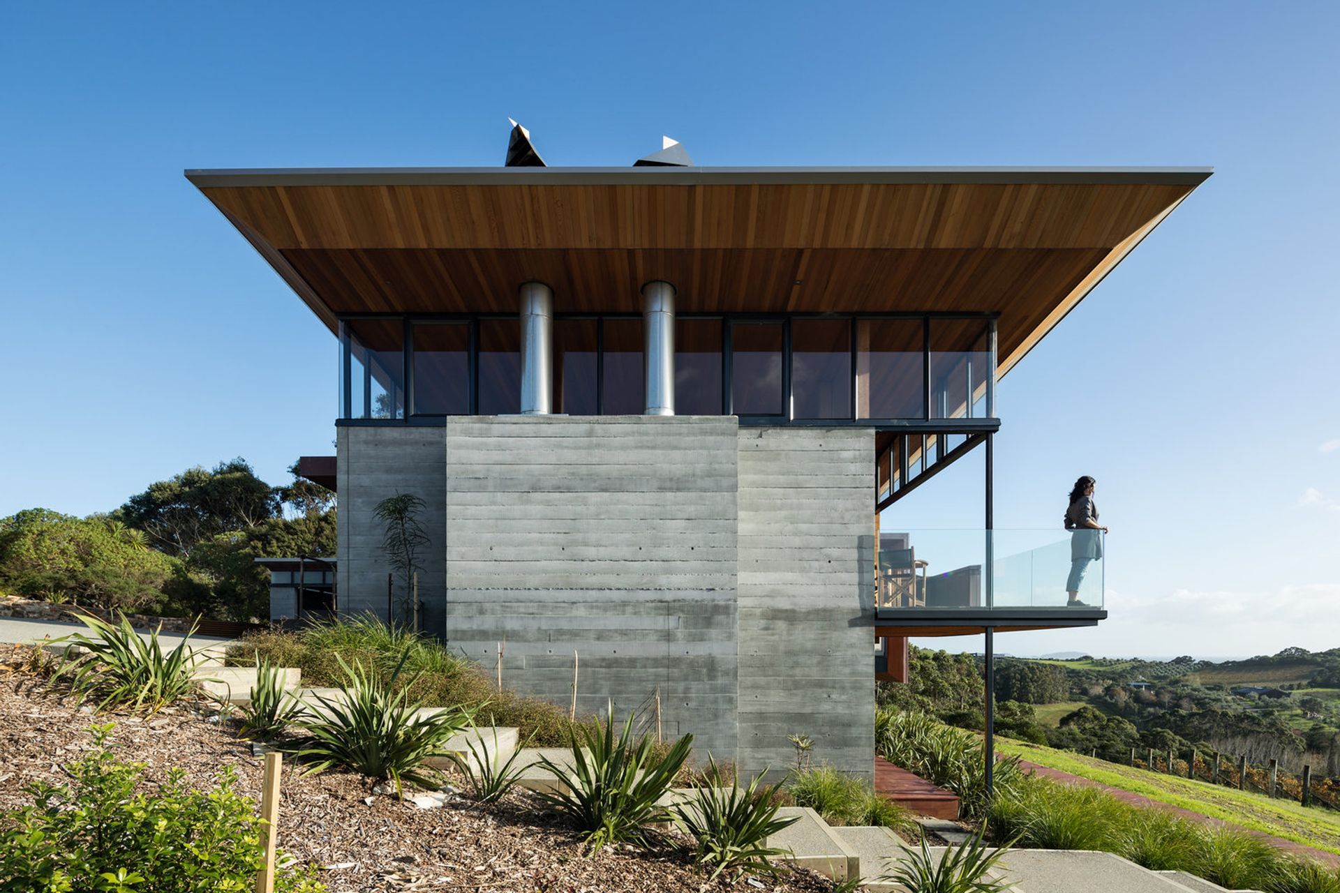 The south-facing end of the building is solid and robust to protect against southerly winds. A balcony overlooks the vineyard.