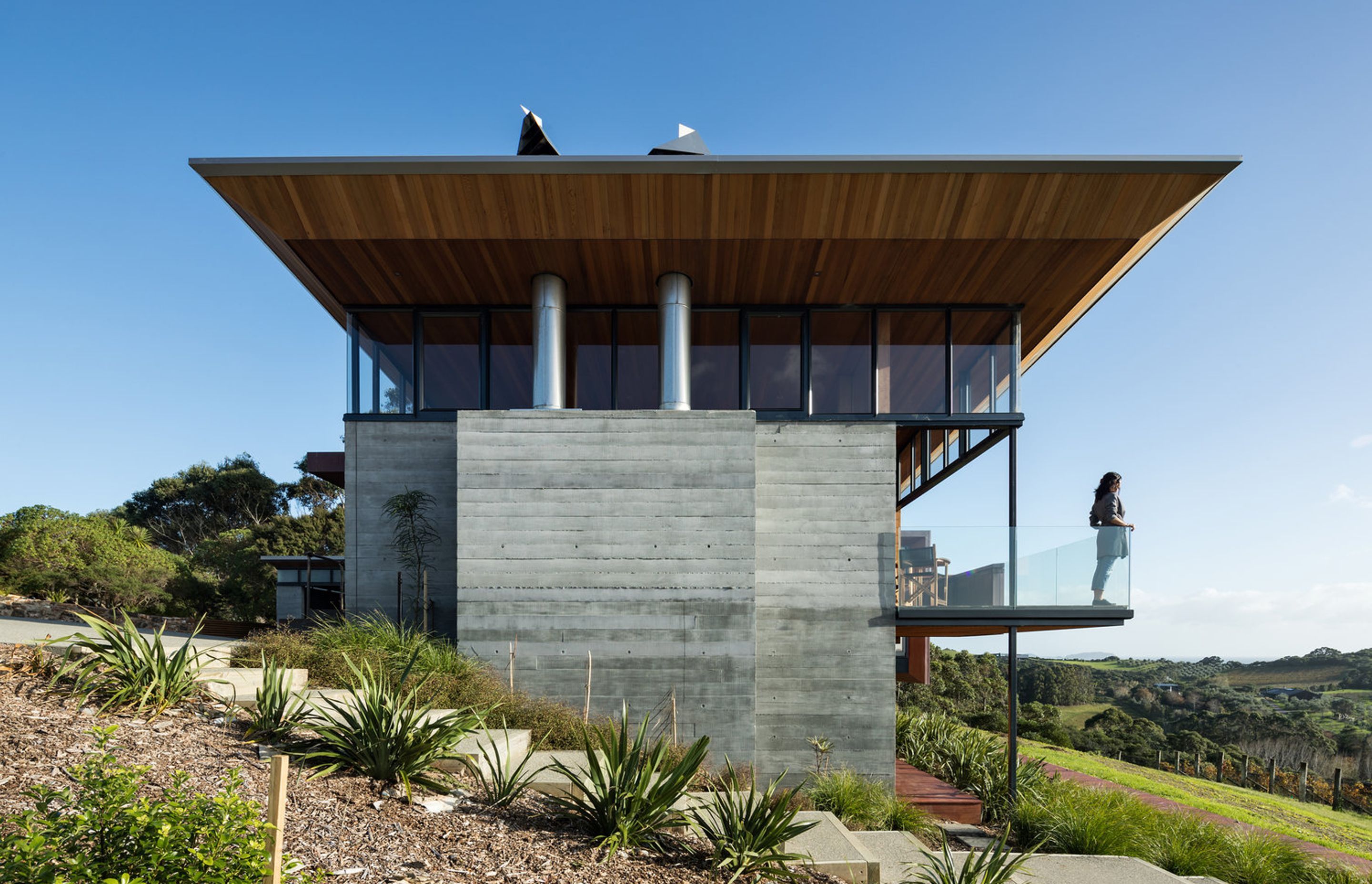The south-facing end of the building is solid and robust to protect against southerly winds. A balcony overlooks the vineyard.