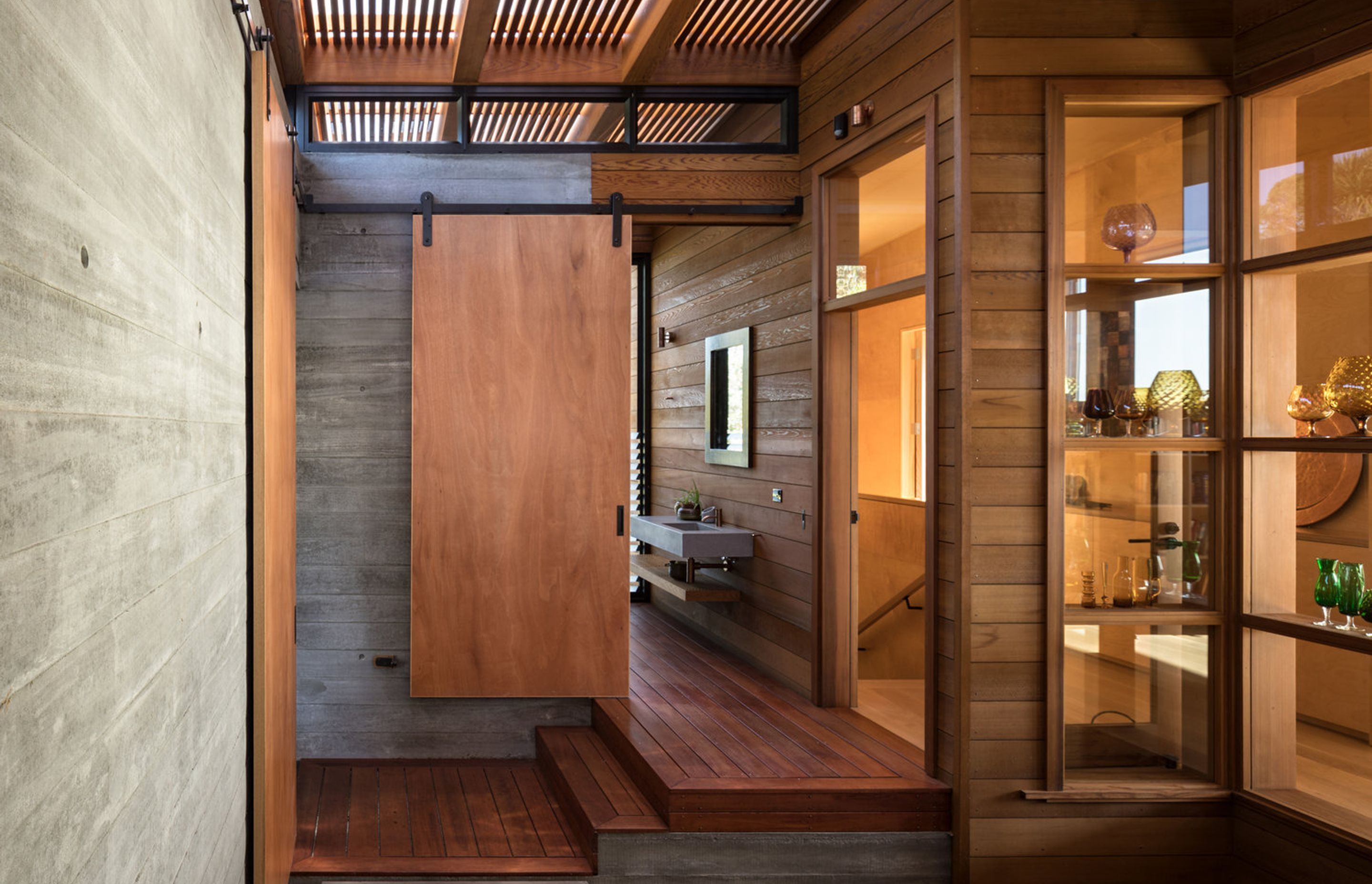 The courtyard leads into the garage (left), the bathroom (centre), the lounge (right) and, inbetween, a staircase leads downstails.