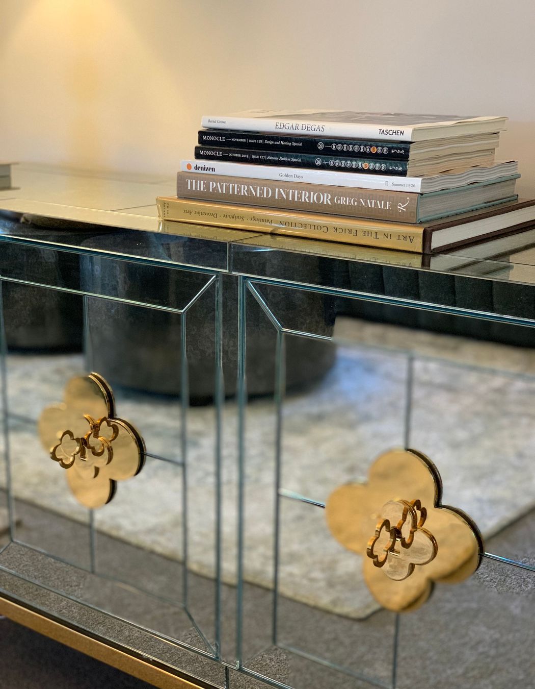Gold detailing on antique mirred glass cabinet