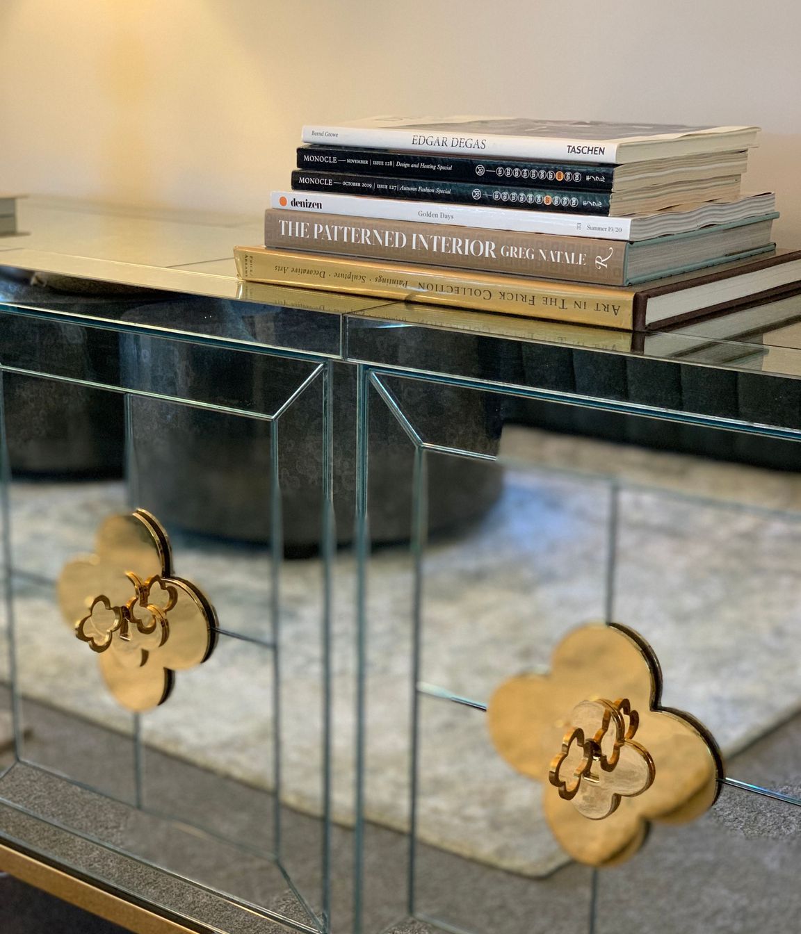Gold detailing on antique mirred glass cabinet