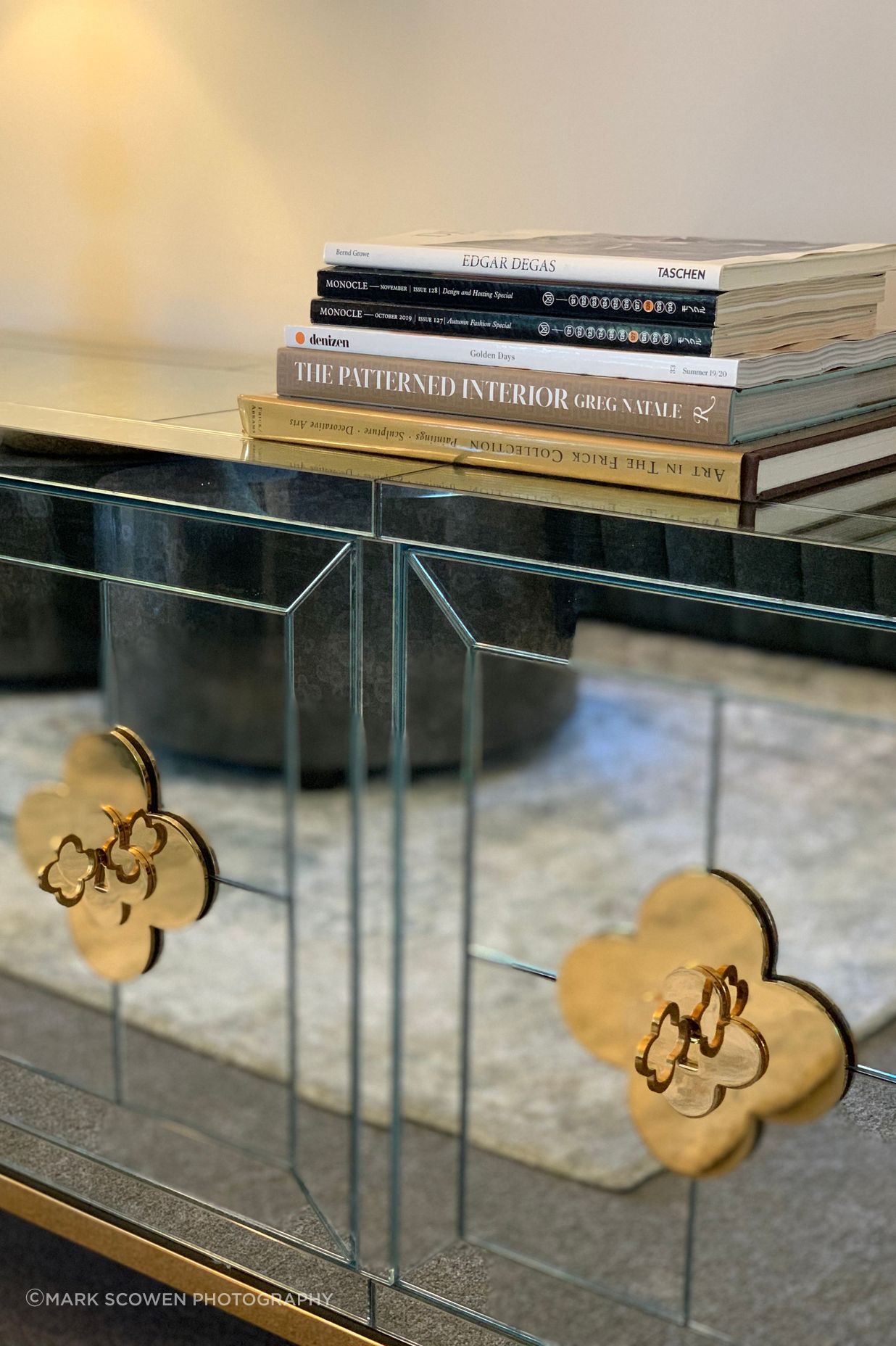 Gold detailing on antique mirred glass cabinet