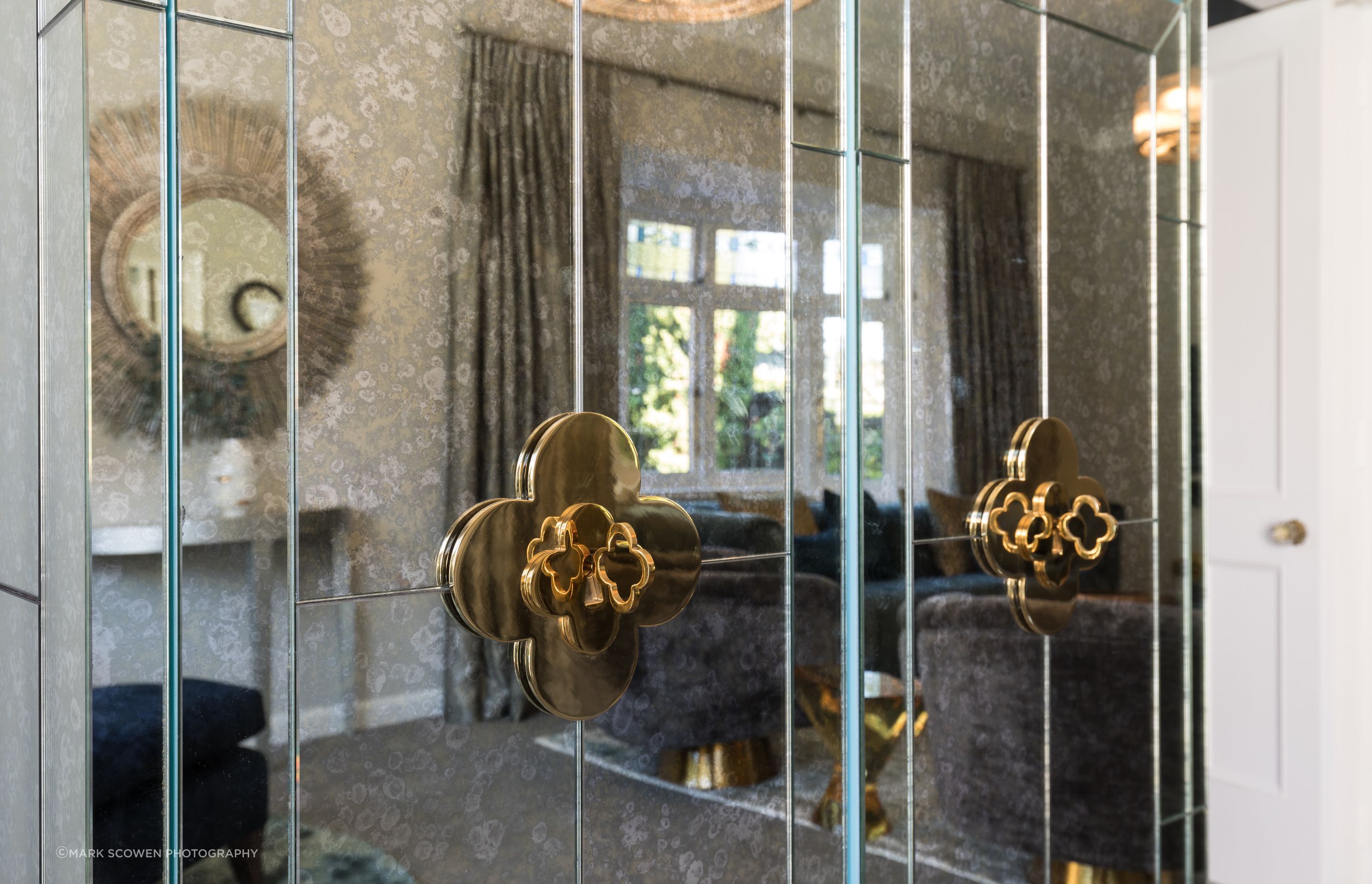 Seeing reflection in the Jonathan Adler drinks cabinet