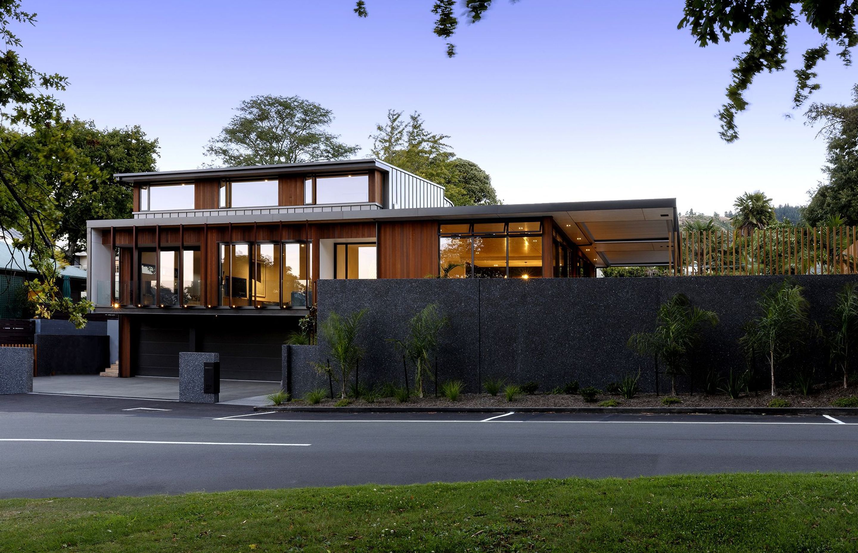 The front elevation at dusk showcases the clever articlulation of forms that help to break down the mass of the building.