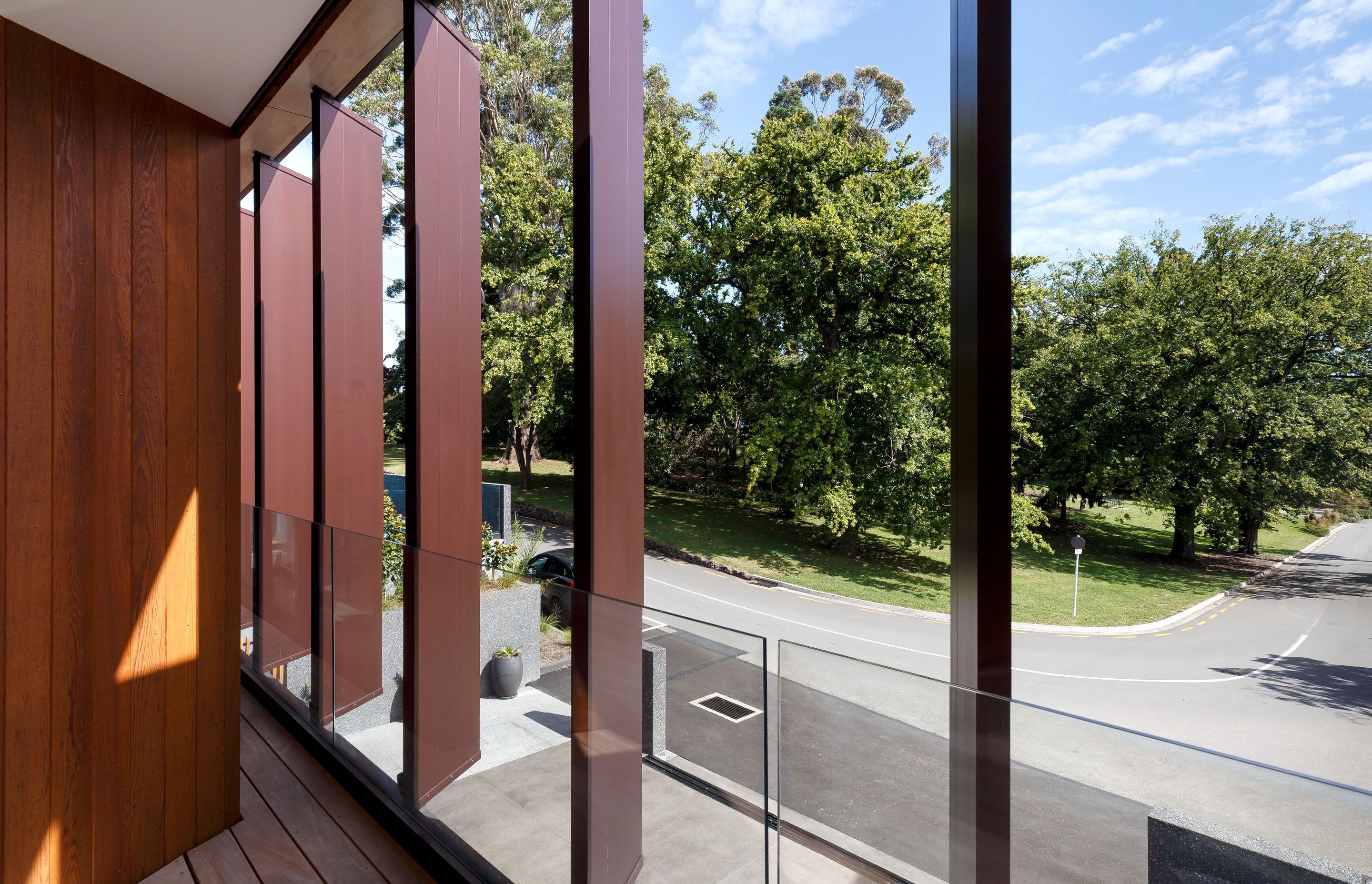 The fixed aluminium louvres provide screening for sun and privacy, and direct views towards the open space greenery