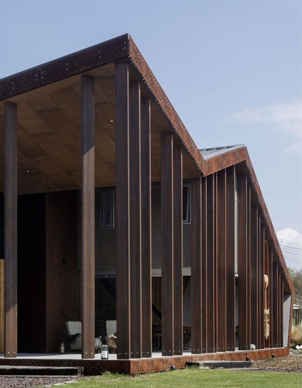 A Metalcraft roof cloaks the exterior and the structure is constructed in concrete block and Cedartech plywood, stained to achieve the desired red scoria and grey tones.