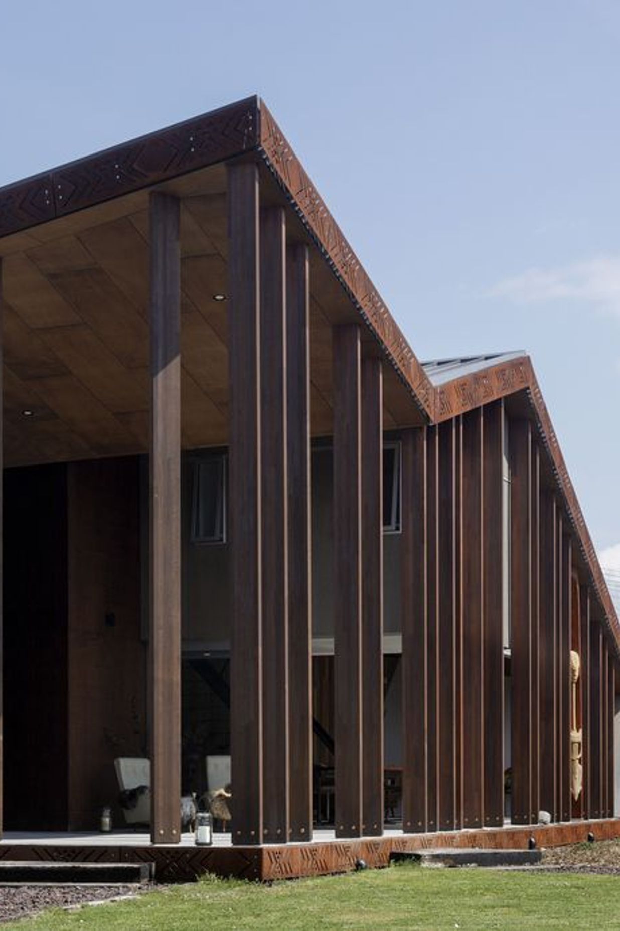 A Metalcraft roof cloaks the exterior and the structure is constructed in concrete block and Cedartech plywood, stained to achieve the desired red scoria and grey tones.