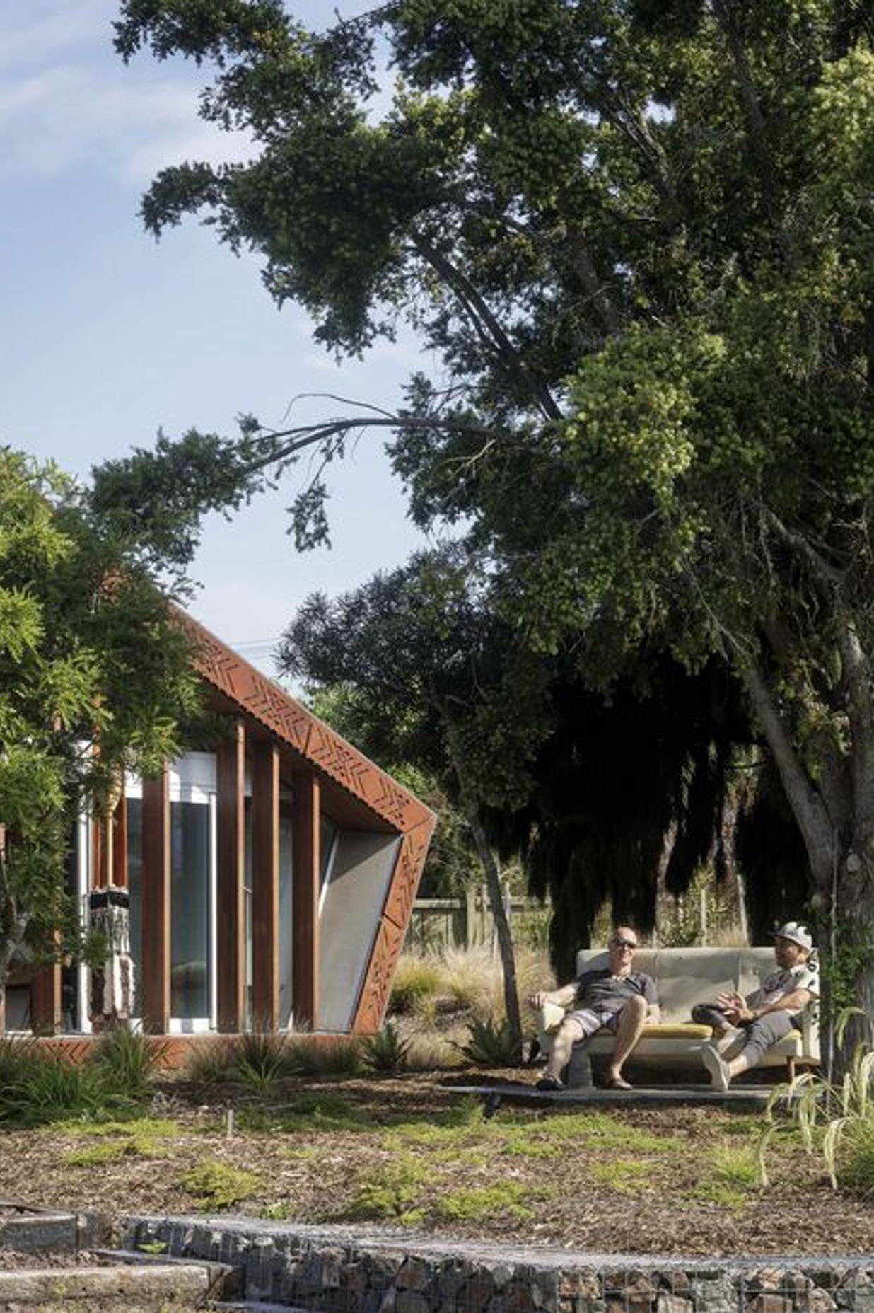The landscaping absorbs references from the architecture, while local native planting is low maintenance.
