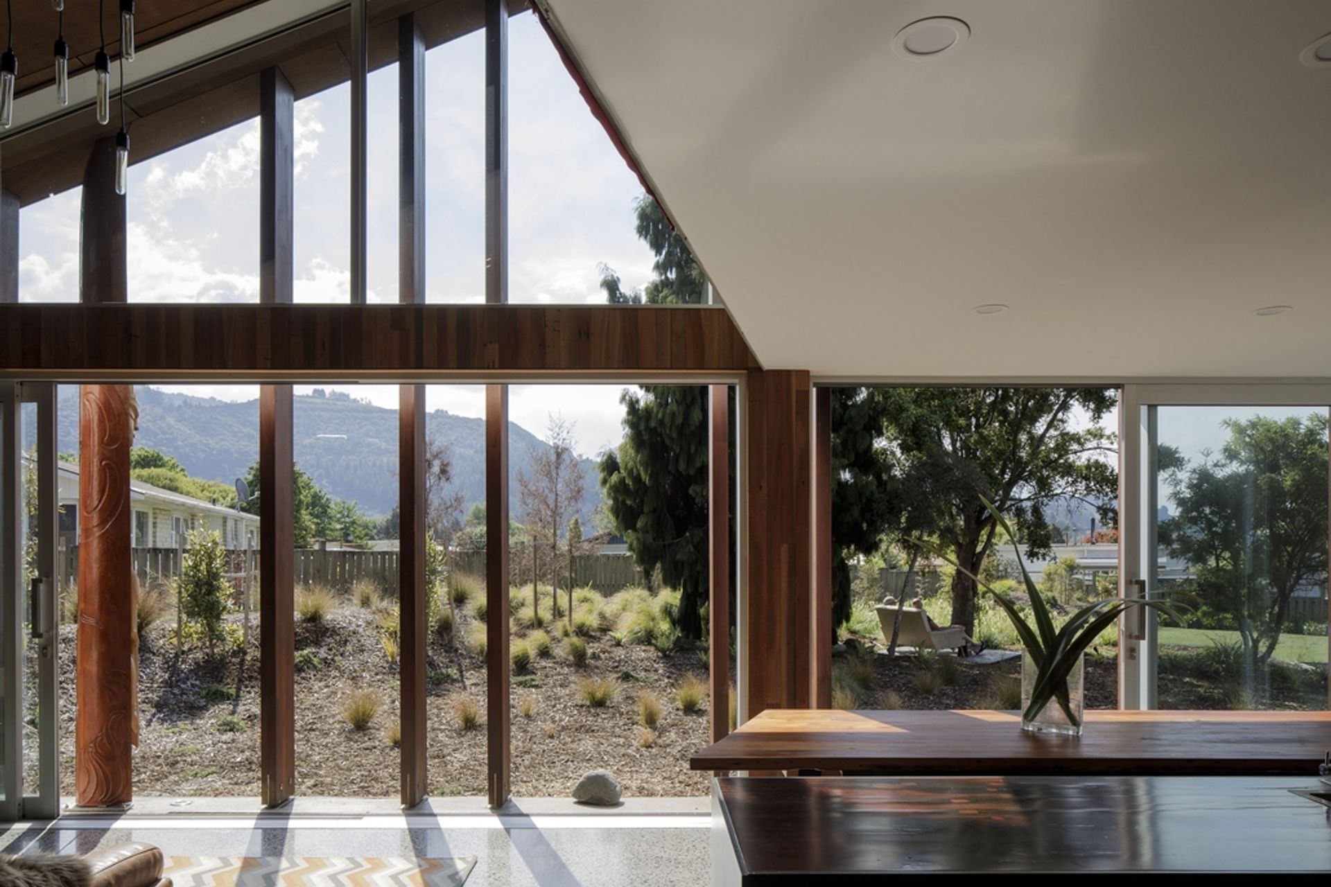 Internally, recycled timber can be seen throughout. In the kitchen area, Totara feature walls, Matai flooring and Jarrah benchtops are offset by white plasterboard walls and ceiling.