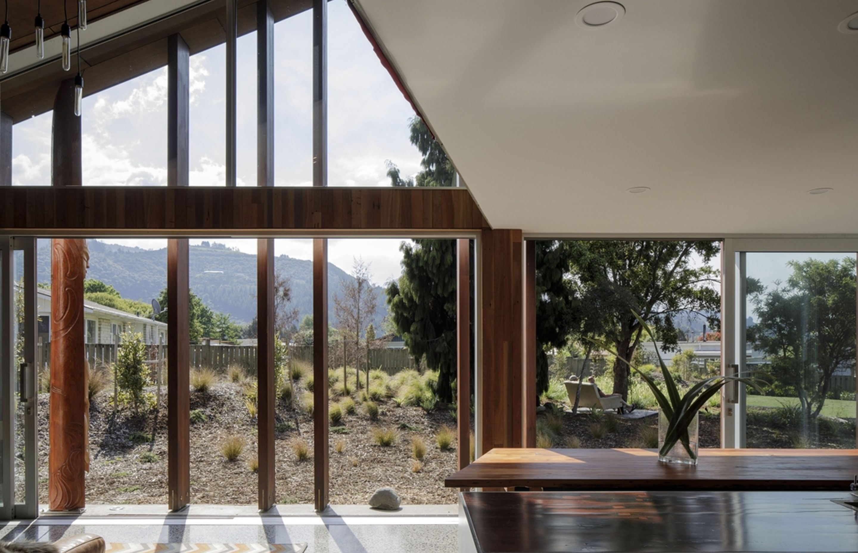 Internally, recycled timber can be seen throughout. In the kitchen area, Totara feature walls, Matai flooring and Jarrah benchtops are offset by white plasterboard walls and ceiling.