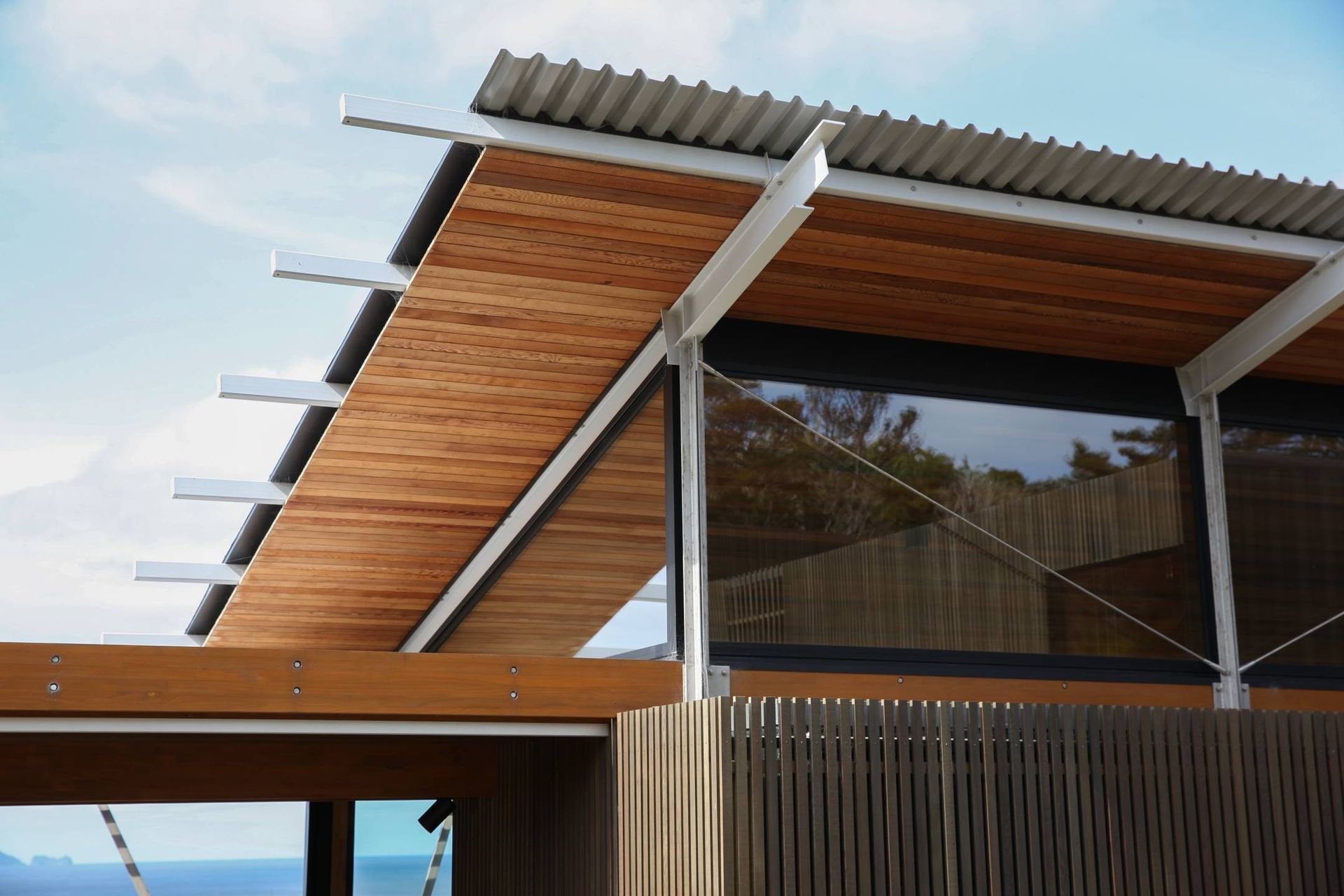 A detail showing the cedar-clad soffit and the steel structure with cable ties providing additional bracing. 