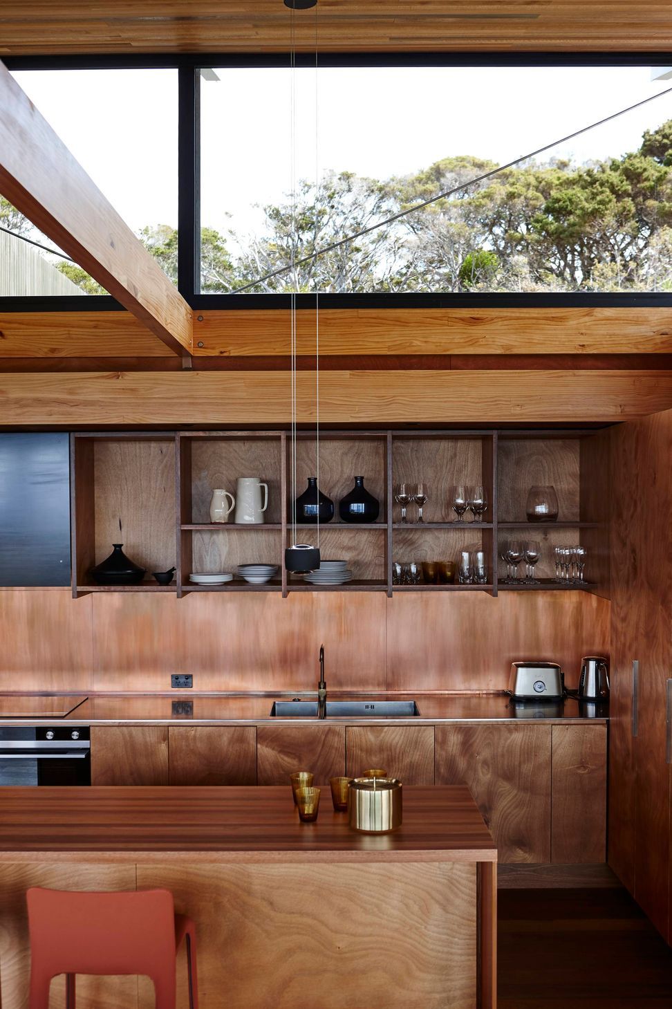 Light spills through the raised roof into the kitchen. Photograph by Jackie Meiring.