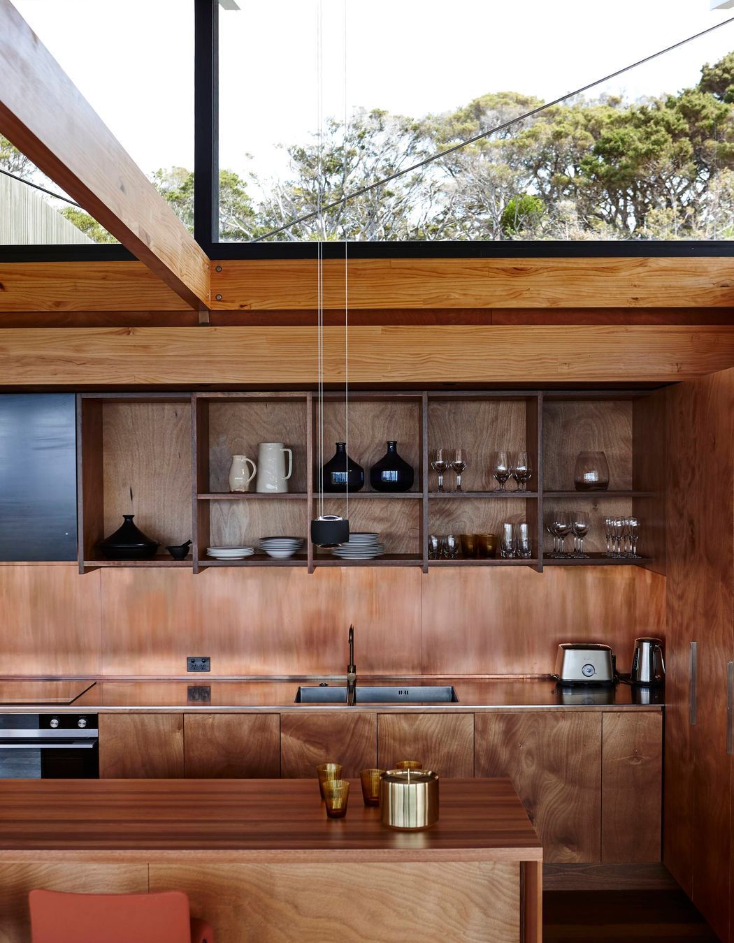 Light spills through the raised roof into the kitchen. Photograph by Jackie Meiring.