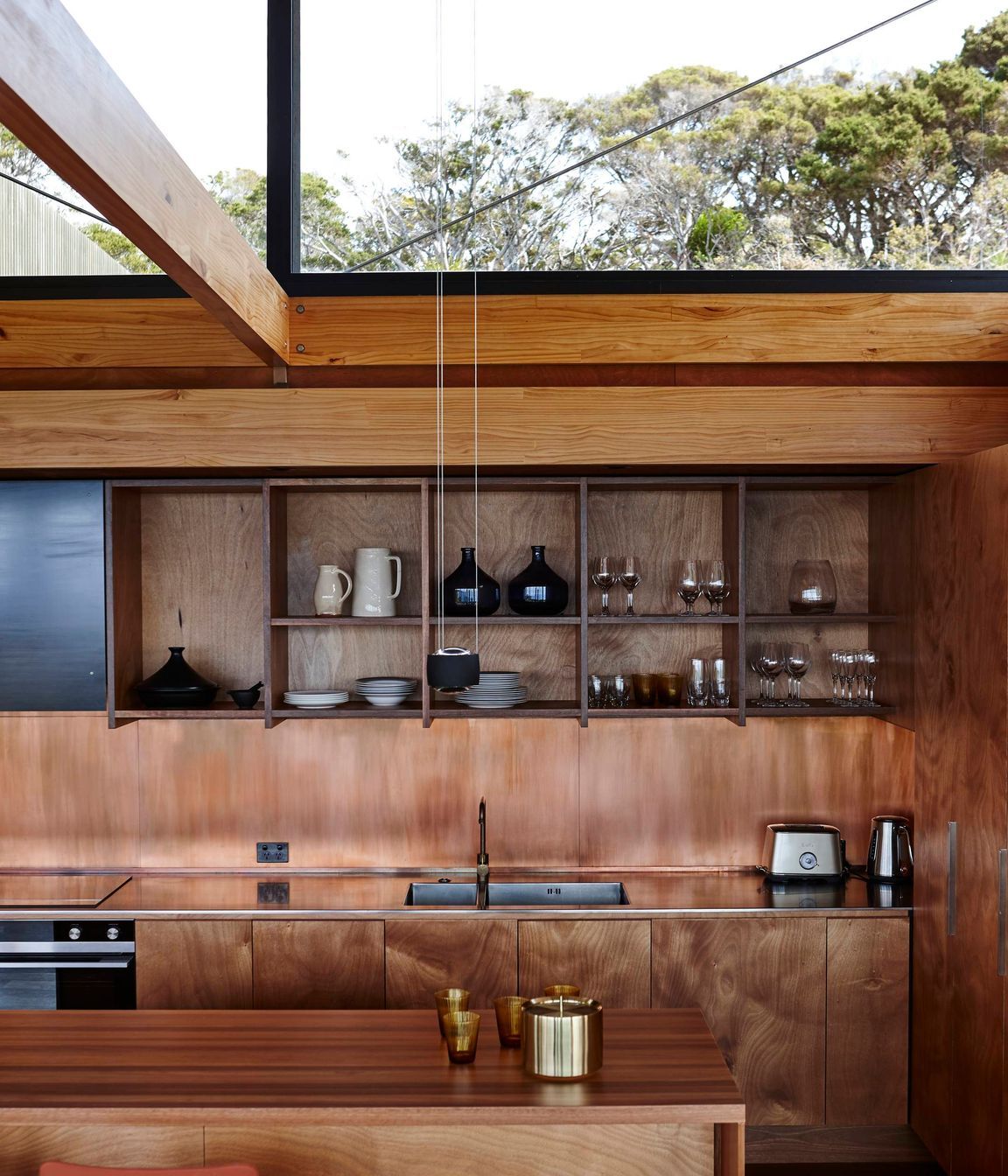 Light spills through the raised roof into the kitchen. Photograph by Jackie Meiring.