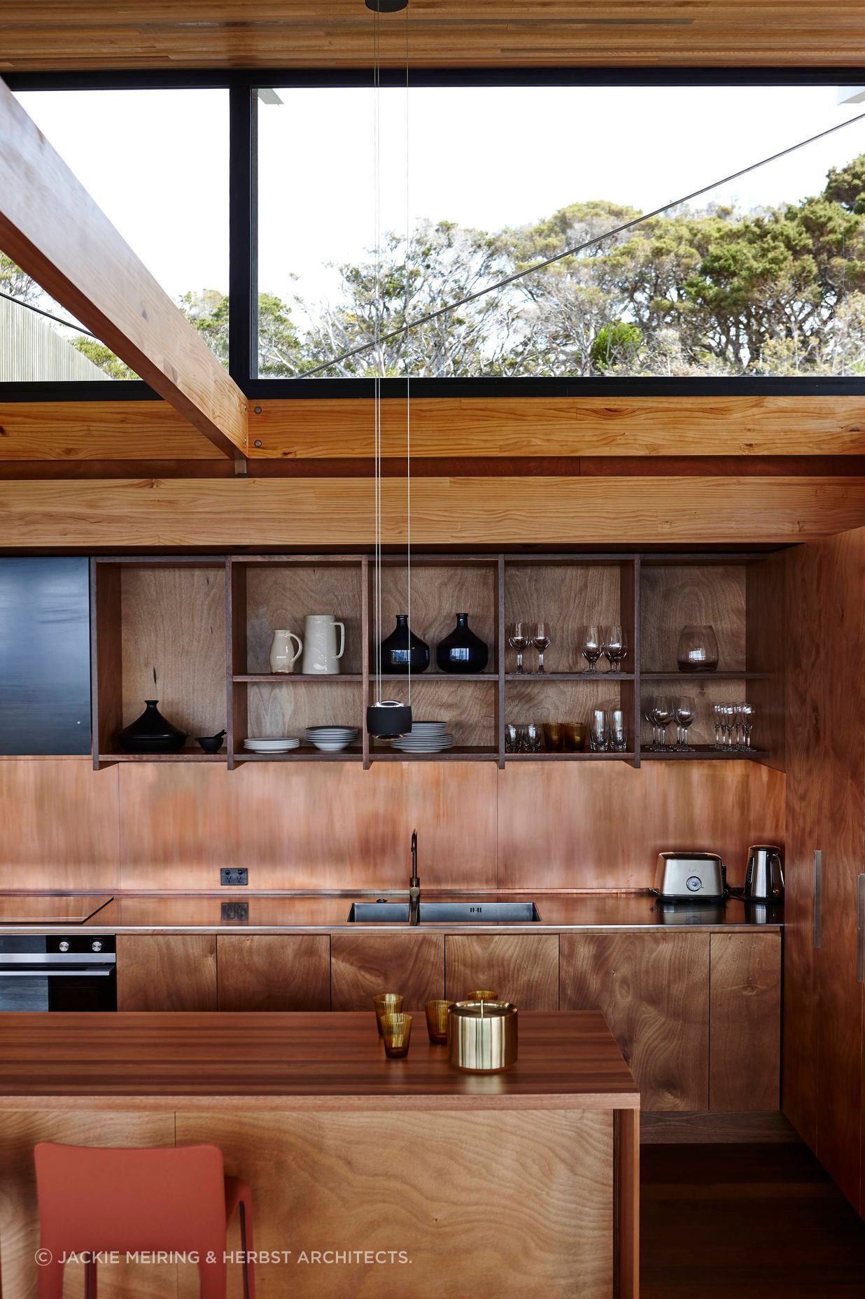 Light spills through the raised roof into the kitchen. Photograph by Jackie Meiring.