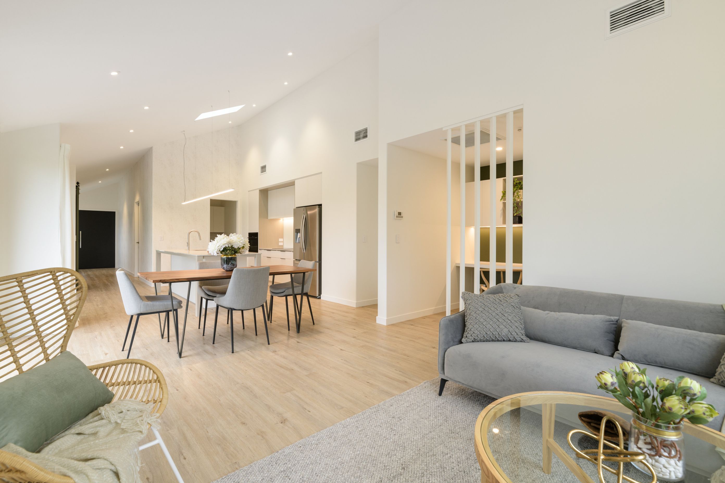 Open plan living incorporating kitchen, family living and office nook, Vida Space flooring and Designers Guild wallpaper
