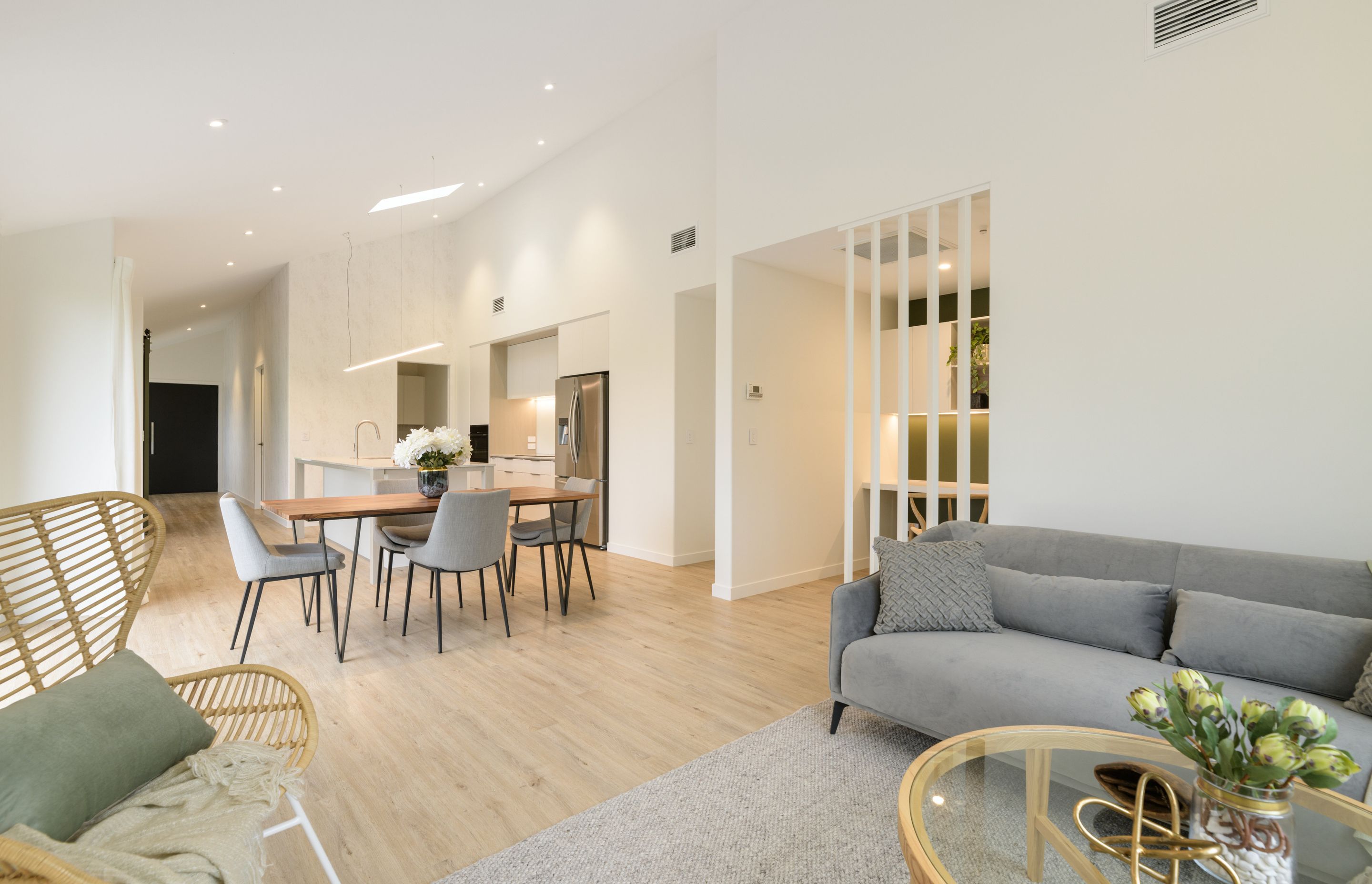 Open plan living incorporating kitchen, family living and office nook, Vida Space flooring and Designers Guild wallpaper