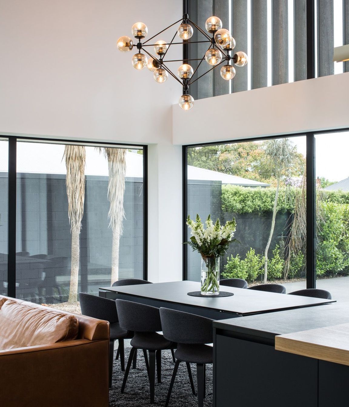 The double-height living area captures all day sun despite the enclosed nature of the sub-divided block.