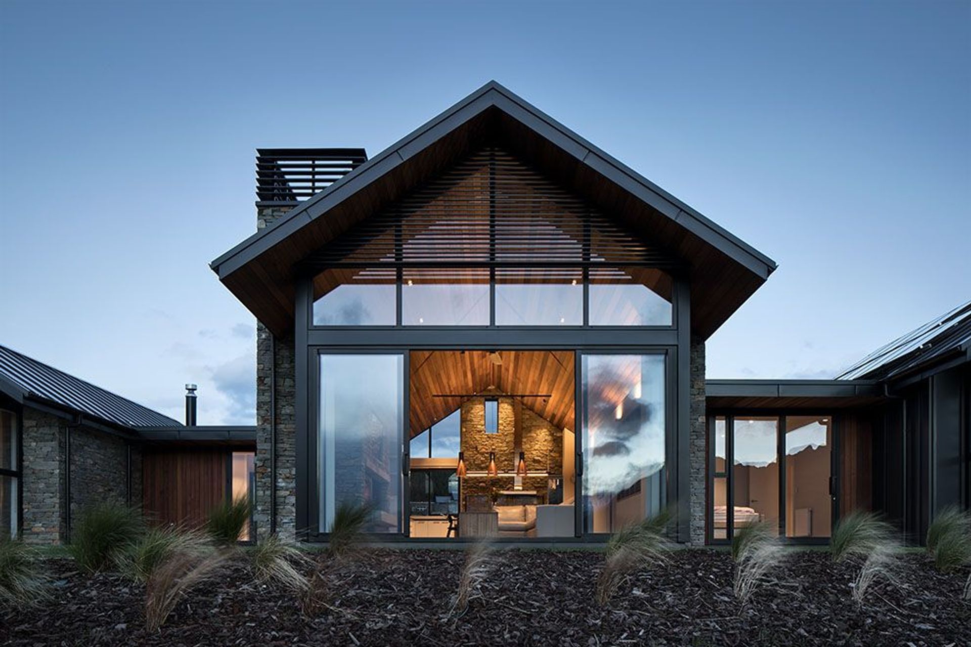 Comprising a trio of pavilions, the design locates living spaces under a central gable and private spaces in the outer wings.