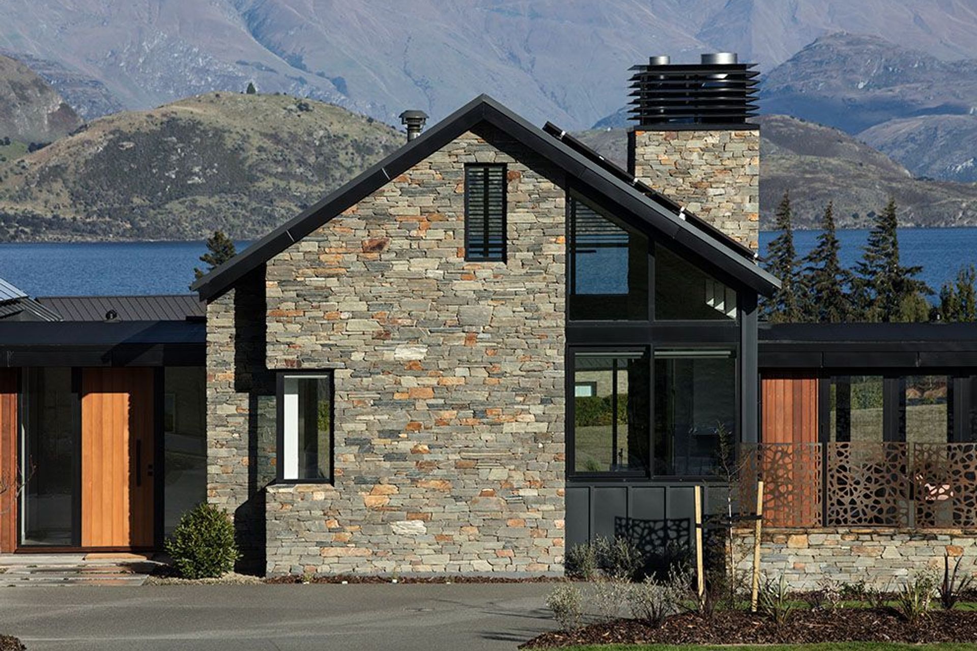 The material palette helps to merge the home with its landscape, with schist playing a big part both in the external cladding and in the interiors, where it is used for accent walls.