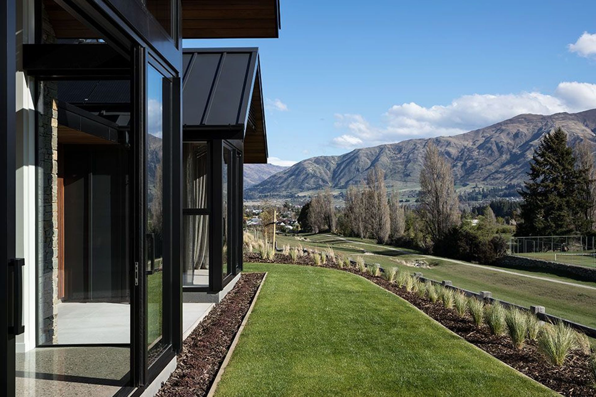 The house sits on an elevated site with views towards Black Peak, Treble Cone and Lake Wanaka.