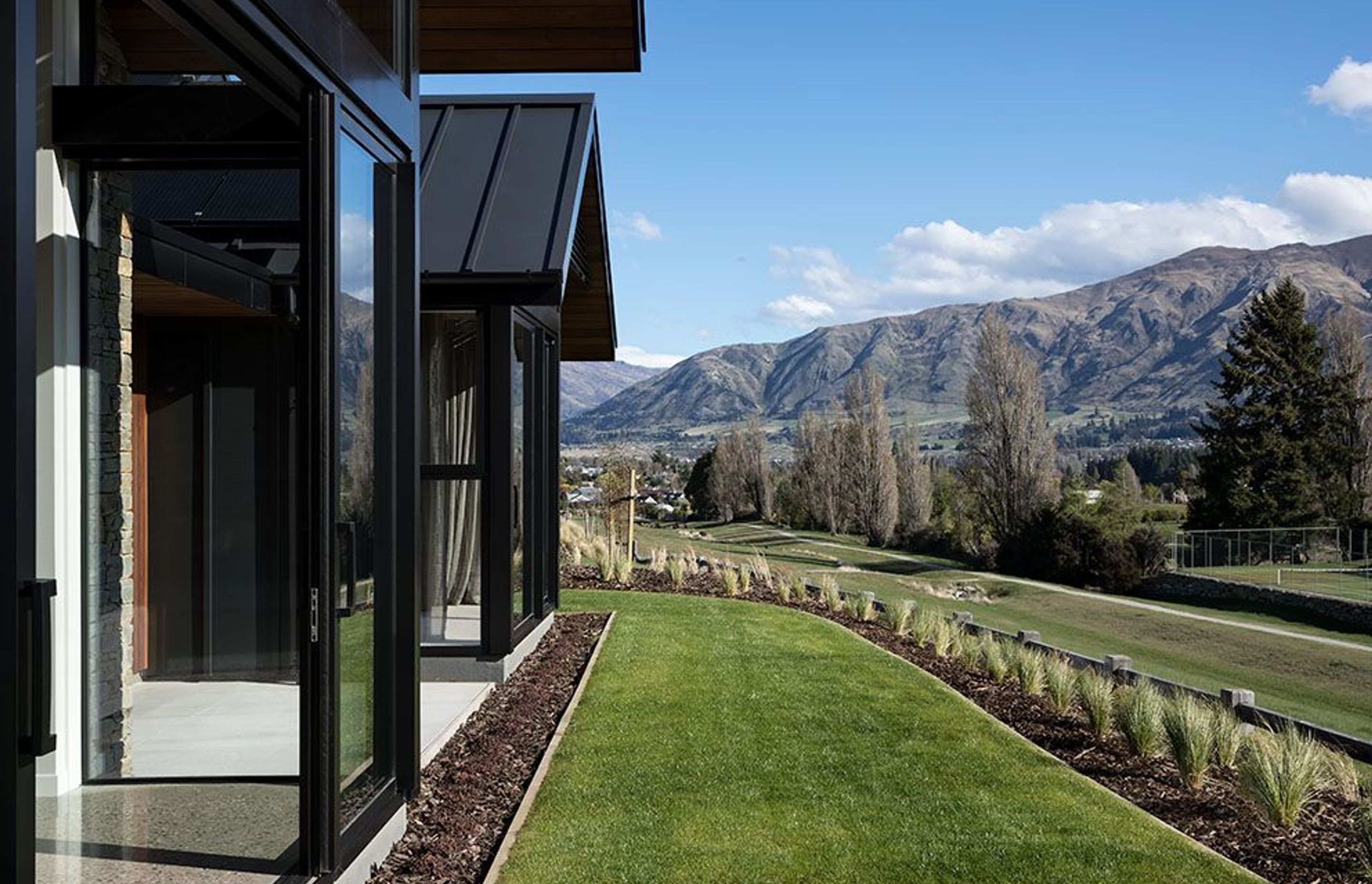 The house sits on an elevated site with views towards Black Peak, Treble Cone and Lake Wanaka.