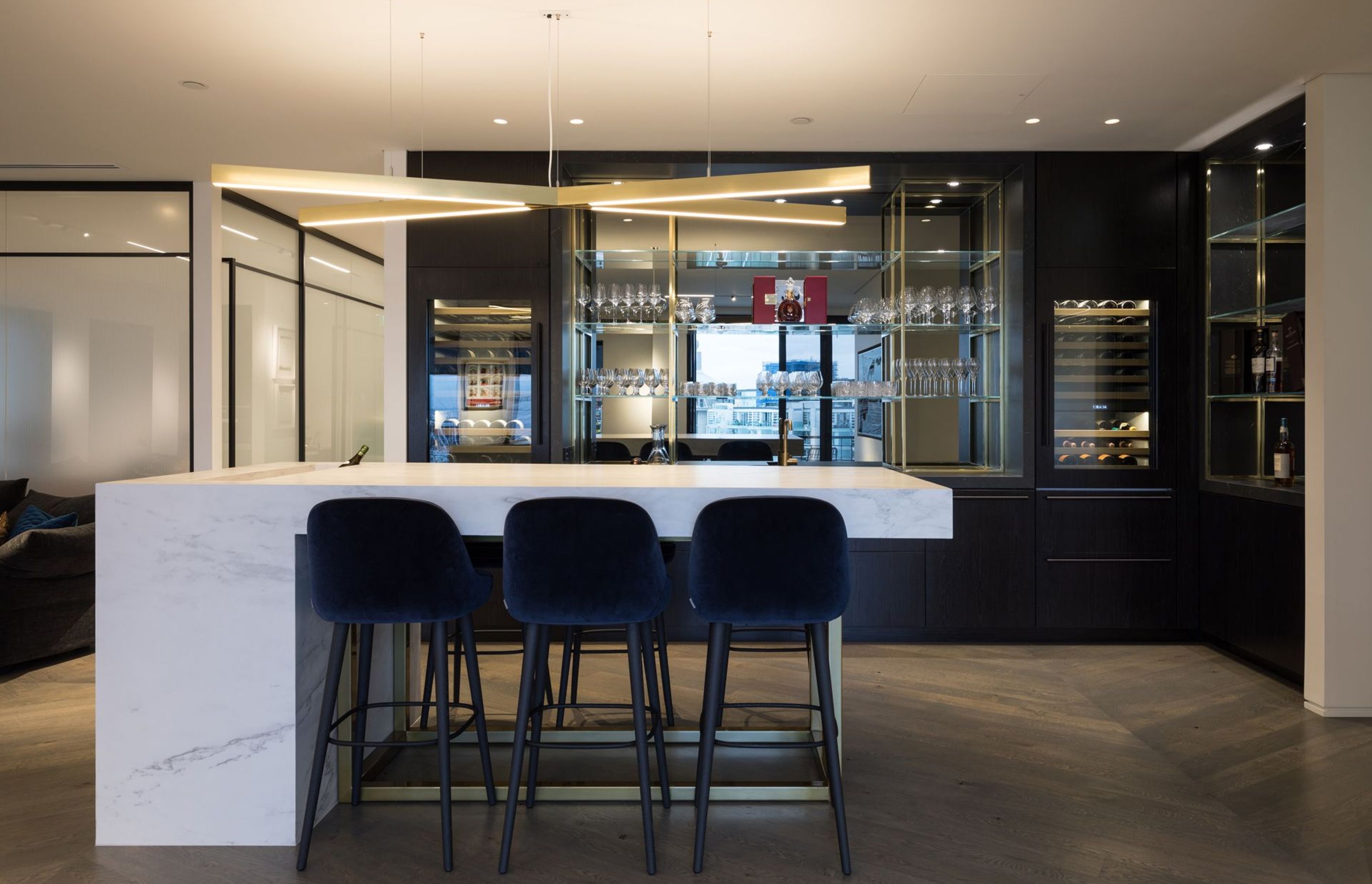 Cantilevered bar with custom joinery for the bar. Herringbone wood floors.