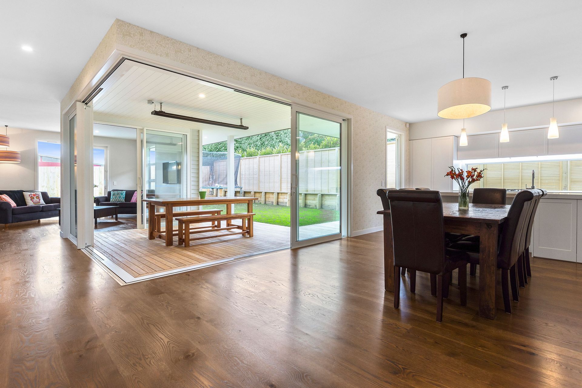 Rustic oak flooring flowing to outdoor decking area.