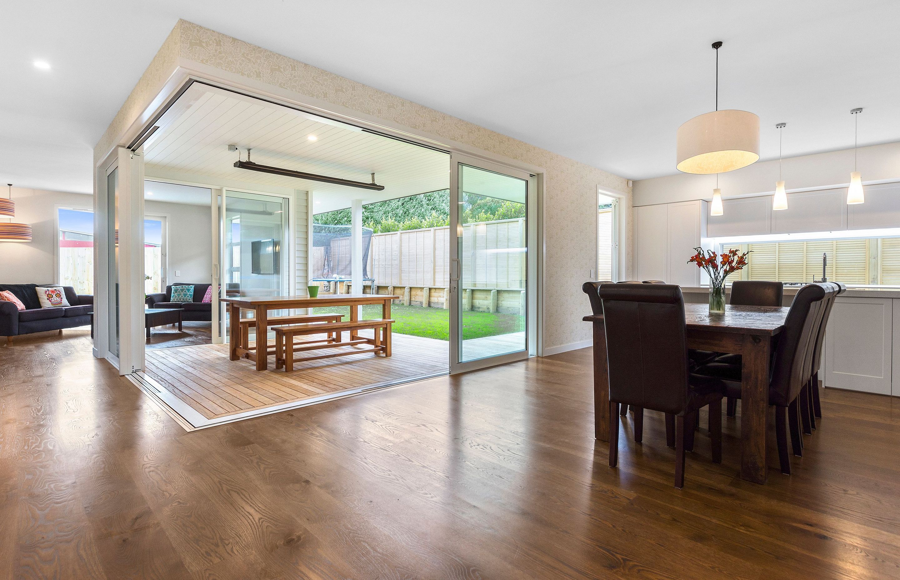 Rustic oak flooring flowing to outdoor decking area.
