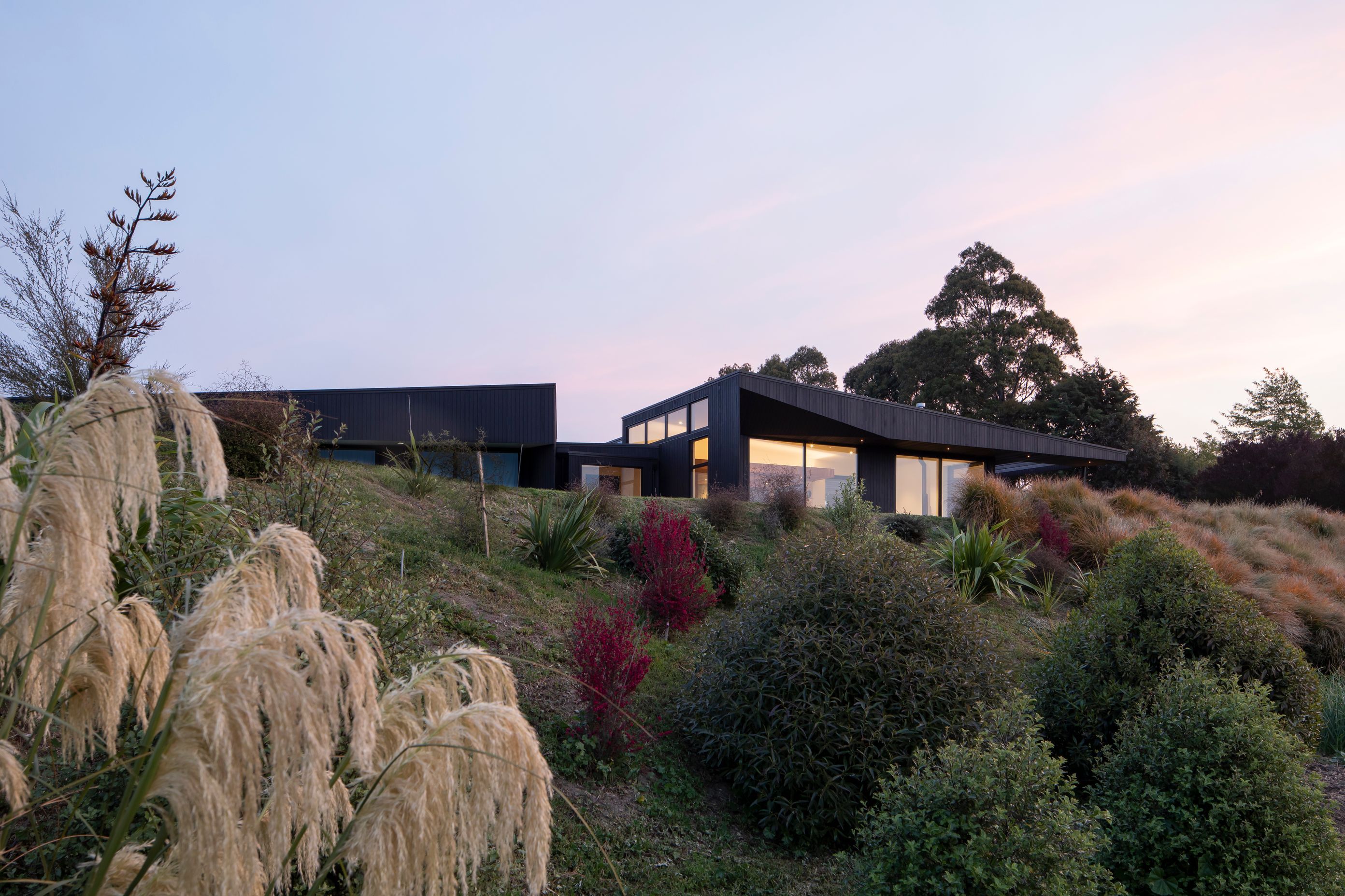 The site is naturally elevated, giving the house sweeping views across the valley and grape vines.