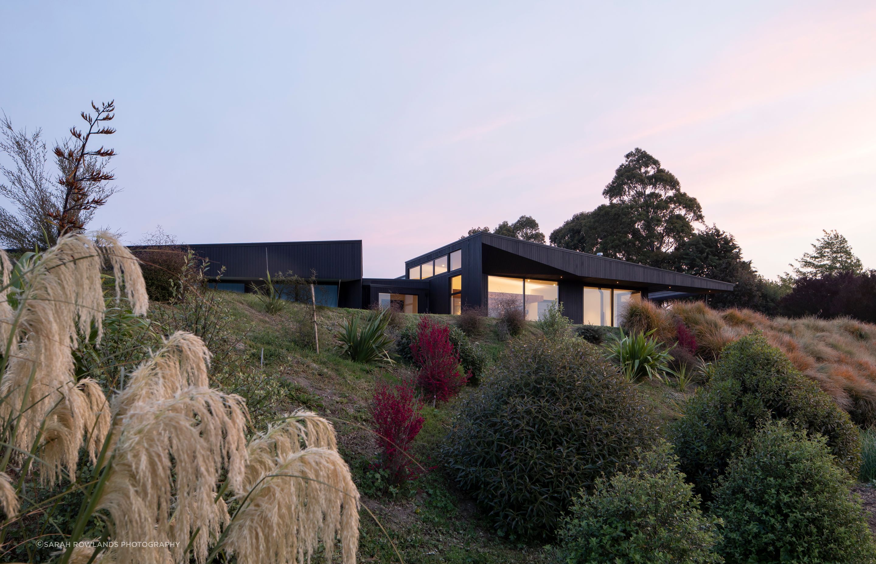 The site is naturally elevated, giving the house sweeping views across the valley and grape vines.