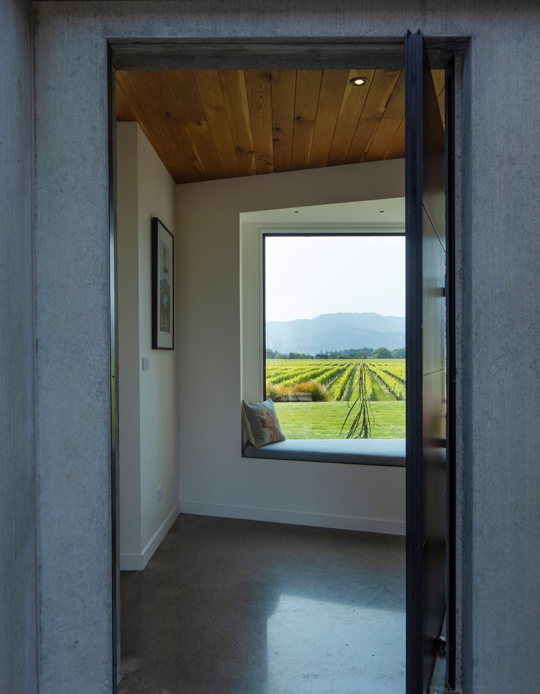 A large picture window and window seat greet visitors; hinting at the expansive views to be had.