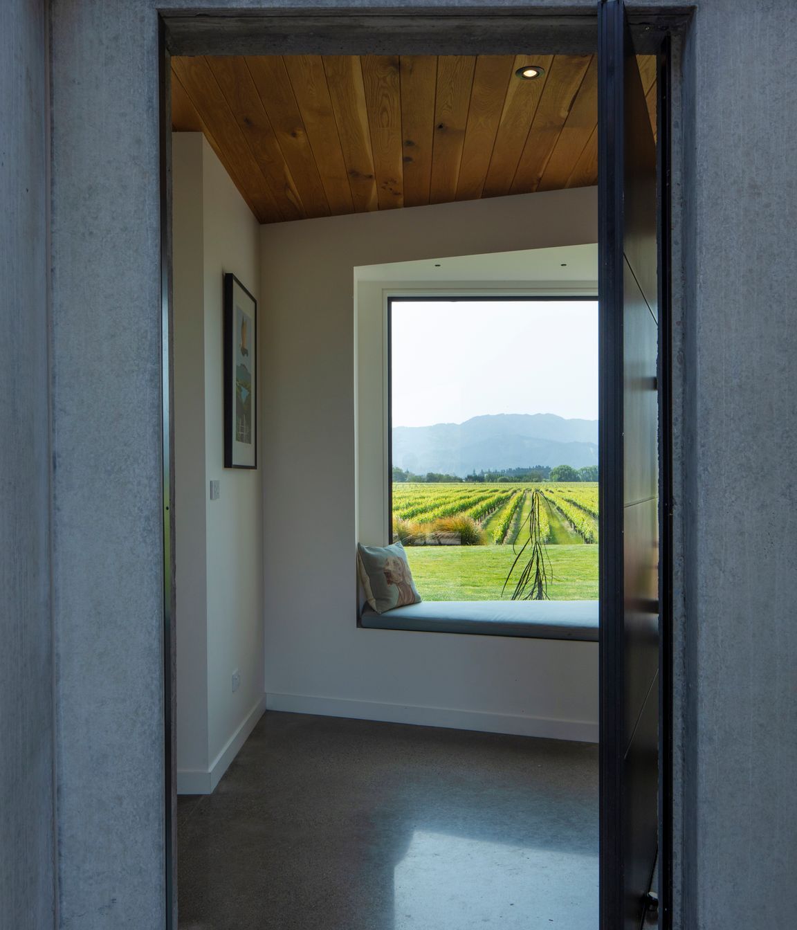 A large picture window and window seat greet visitors; hinting at the expansive views to be had.