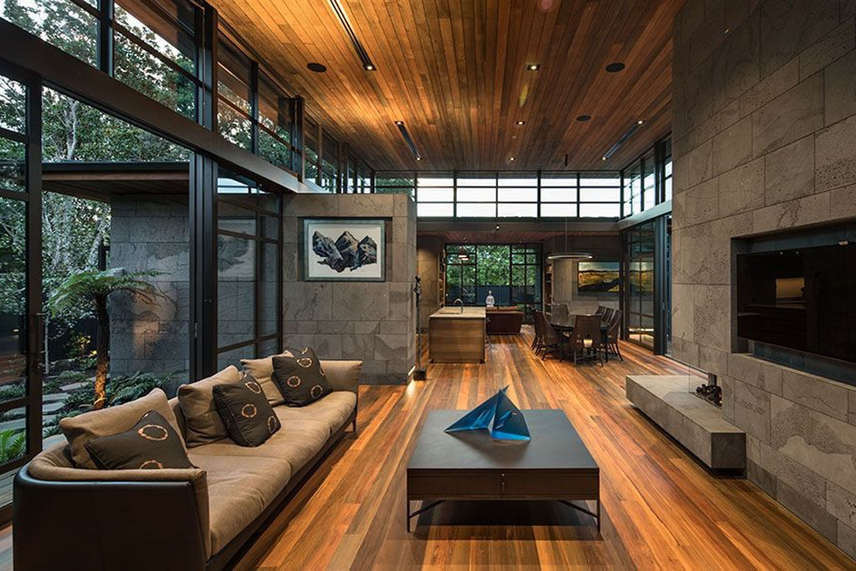 Looking through the living area to the kitchen and dining areas, and the library/lounge space at the far end.