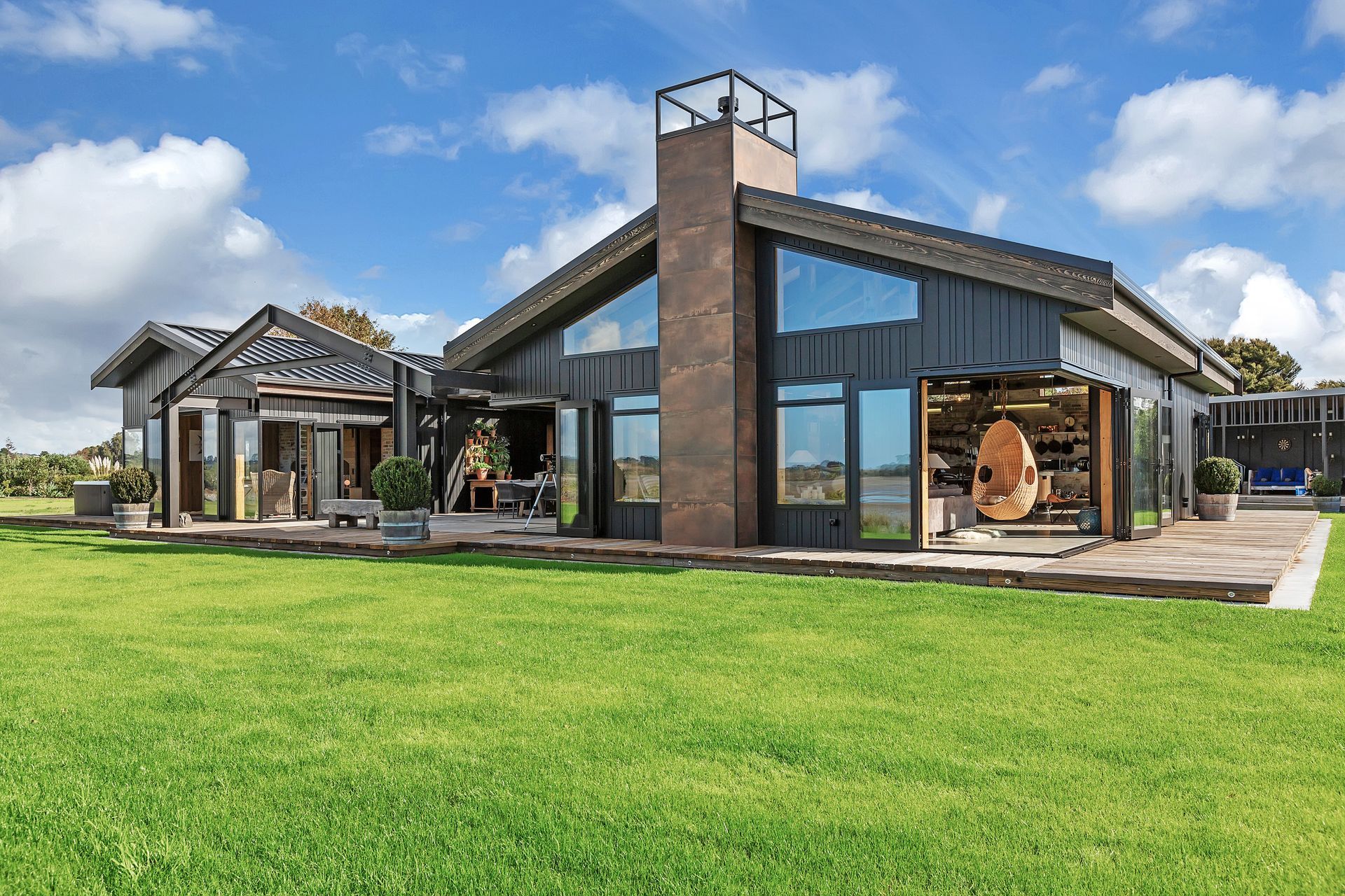 A pair of gabled forms bookend a central courtyard. Durable cladding was specified to mitigrate the effects of being sited within a coastal environment.