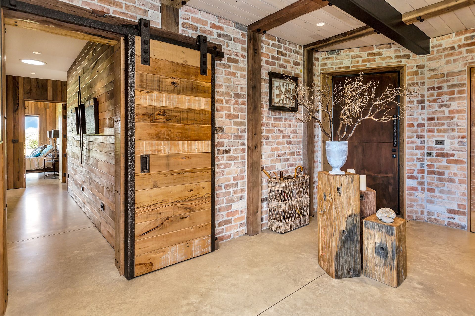The entrance way features a handmade rimu-and-steel sliding barn door and recyled bricks from 'Real Groovy Records' building in Auckland and the Albion Hotel in Gisborne.