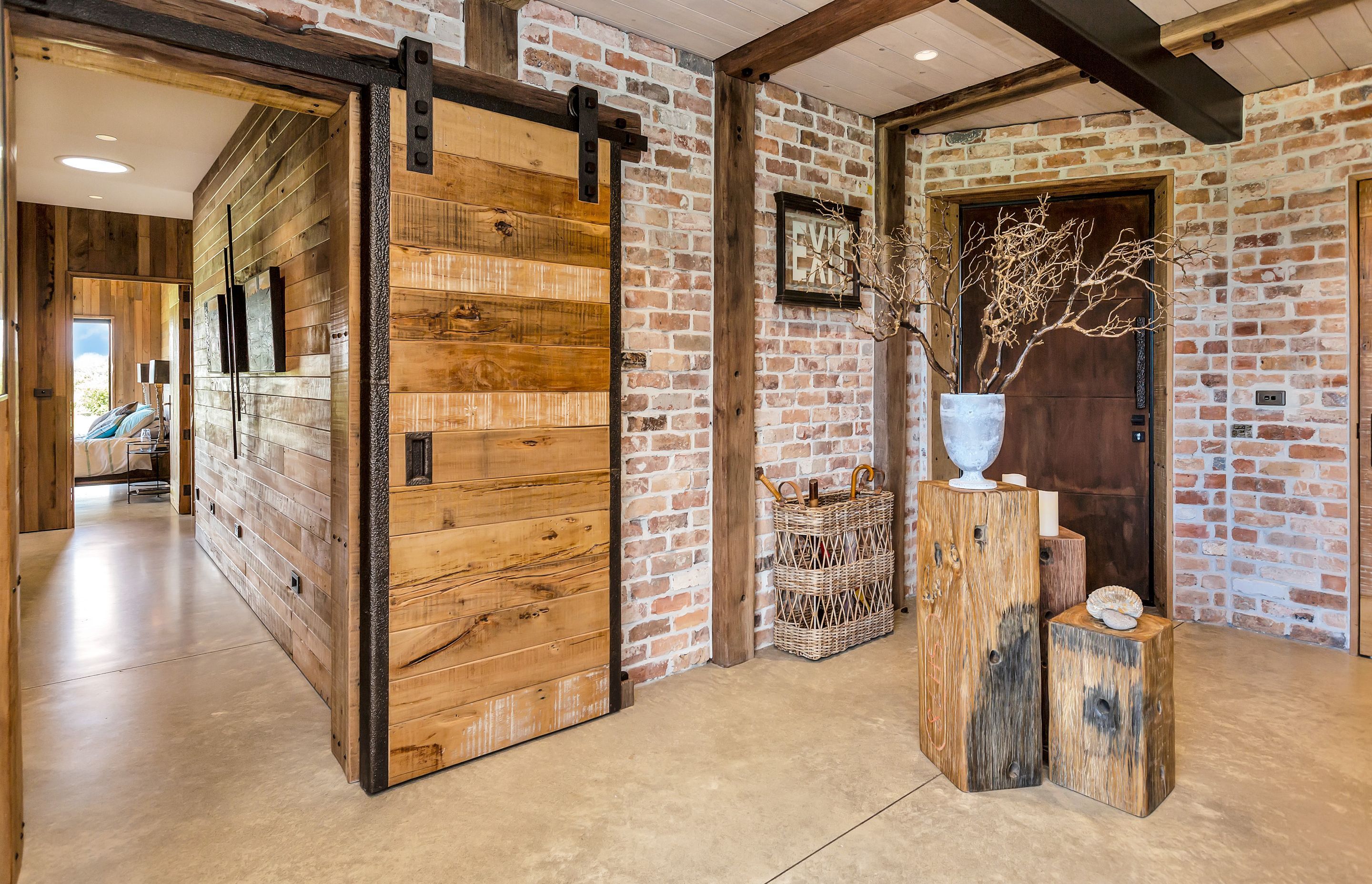 The entrance way features a handmade rimu-and-steel sliding barn door and recyled bricks from 'Real Groovy Records' building in Auckland and the Albion Hotel in Gisborne.