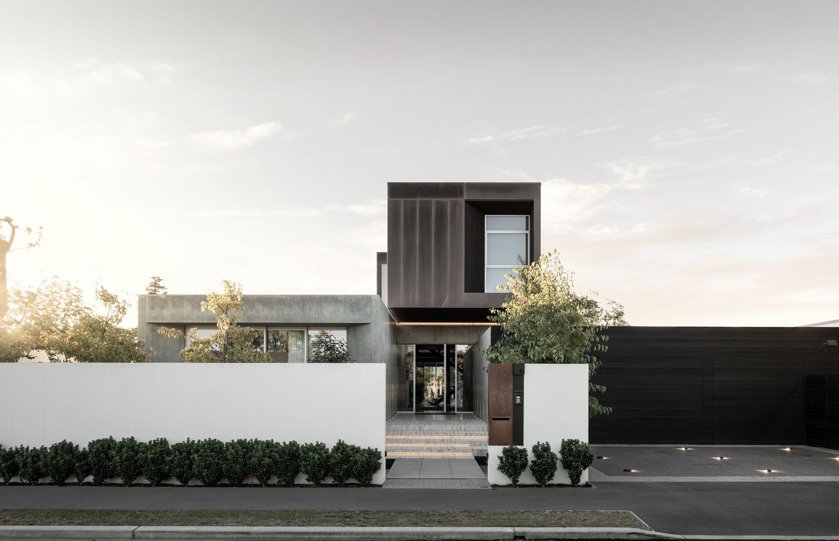 A box, sculpted out of copper and cedar, has been elevated and cantilevered high above the streetscape to create a dramatic sense of entry, at ground level, a series of concrete forms anchor the building to the site.