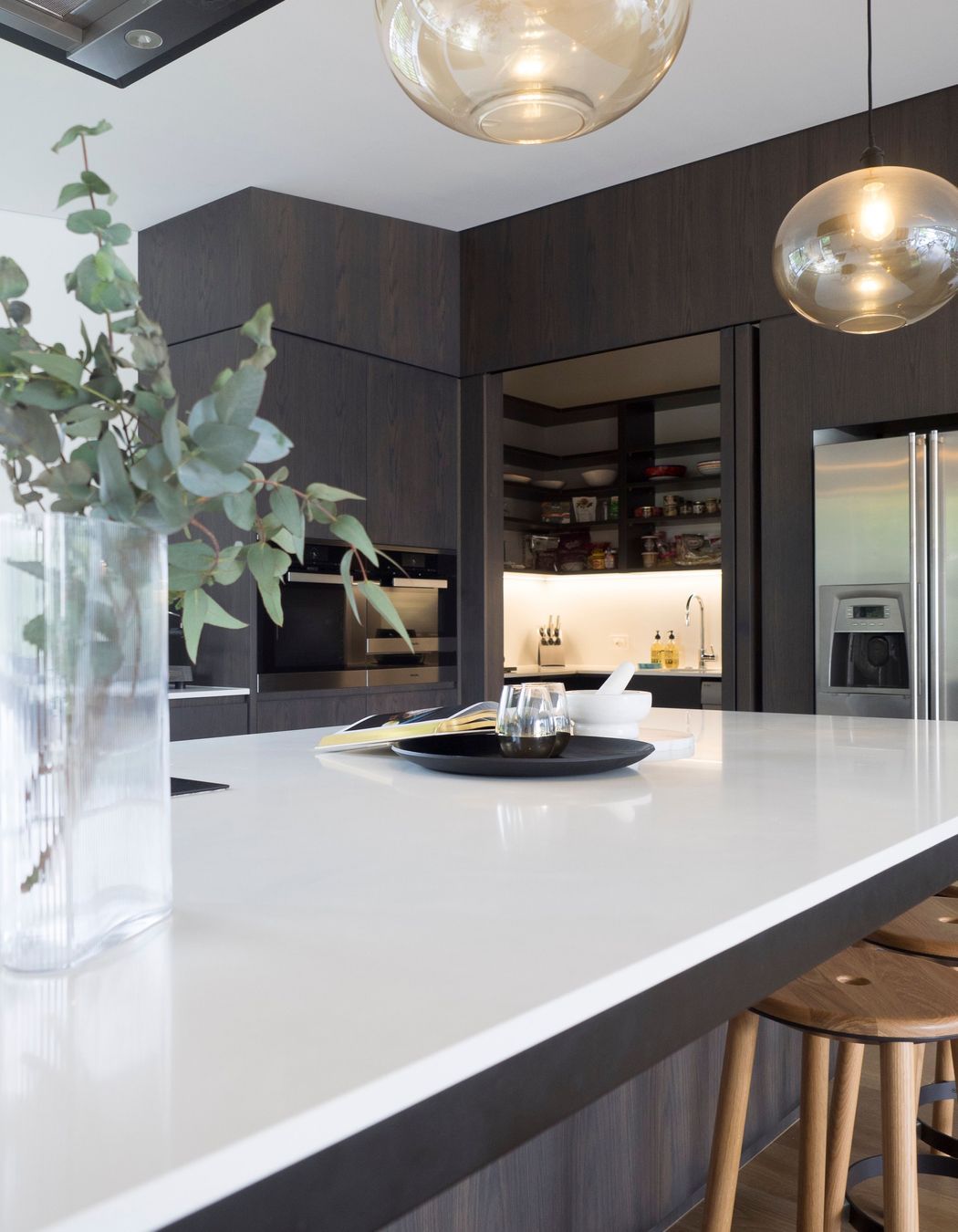 A scullery hiddin behind internal bifolds includes an extra dishwasher and wine fridge. Perfect for entertainers.