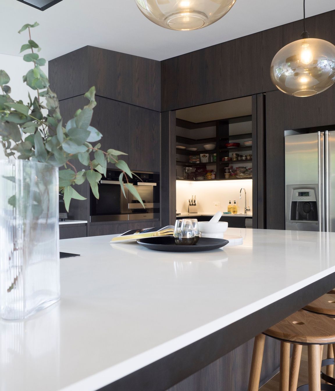 A scullery hiddin behind internal bifolds includes an extra dishwasher and wine fridge. Perfect for entertainers.