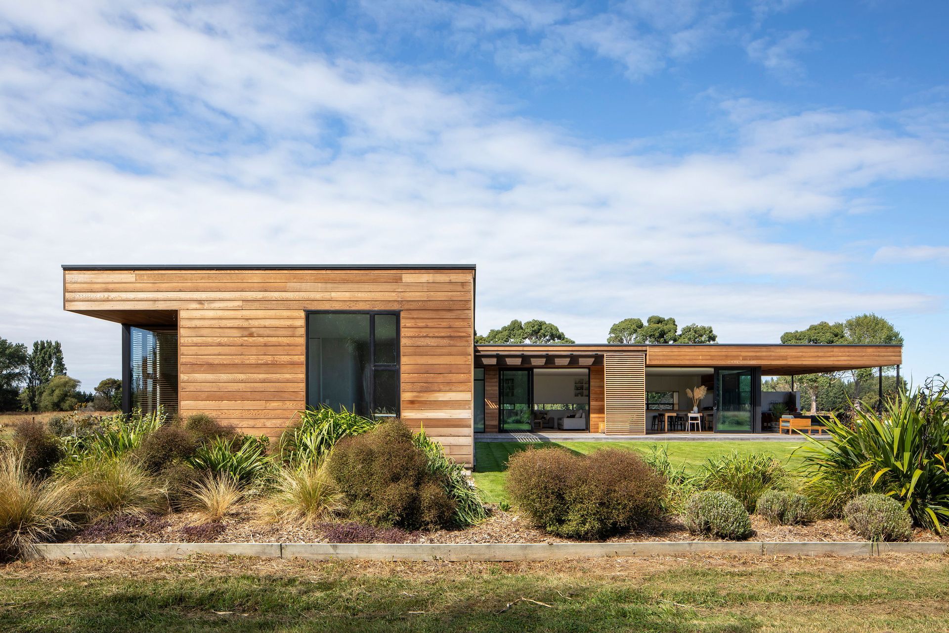The end of the bedroom wing has floor-to-ceiling windows that take in views of the surrounding landscape.
