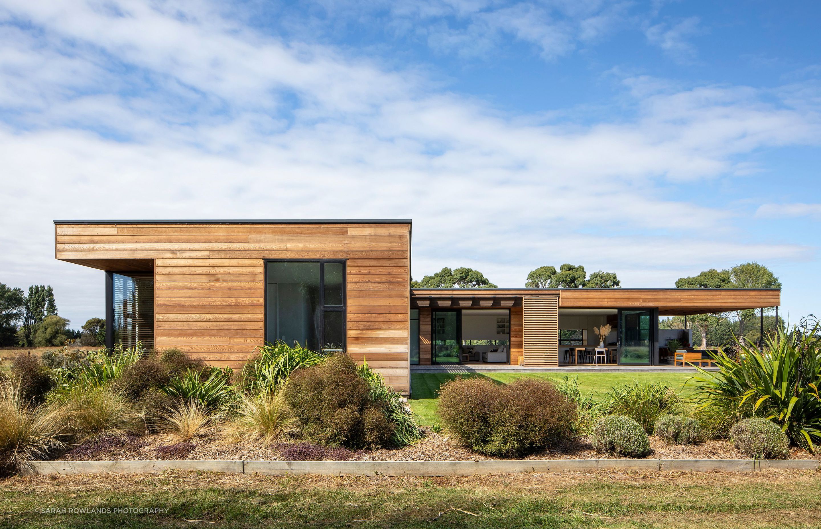 The end of the bedroom wing has floor-to-ceiling windows that take in views of the surrounding landscape.