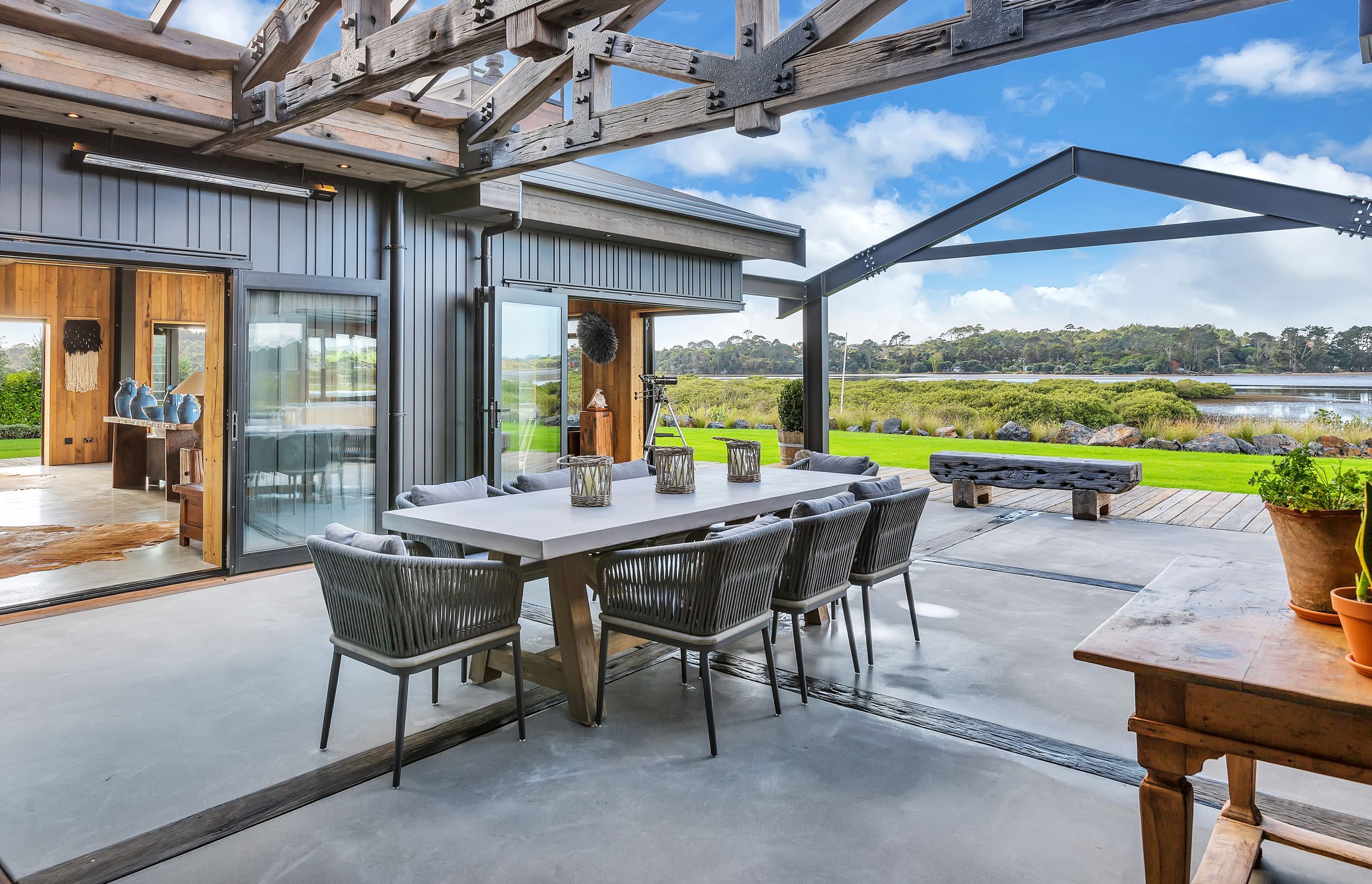 The central courtyard is covered with recycled timber trusses and a new steel gabled element that frames the waterfront view.